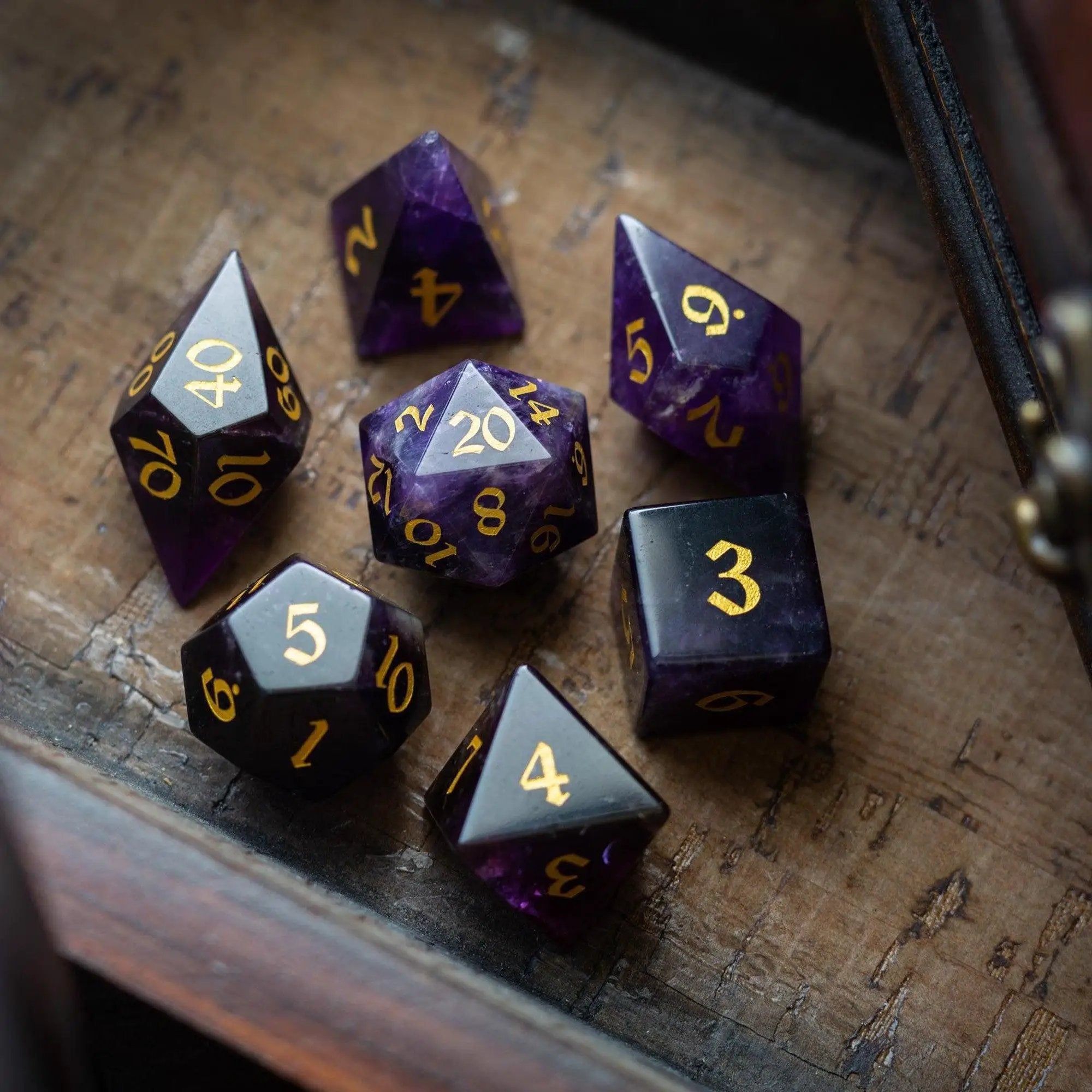 Purple Amethyst gemstone DND dice set with elven cut design by Runic Dice, featuring intricately carved, vibrant gemstone dice.