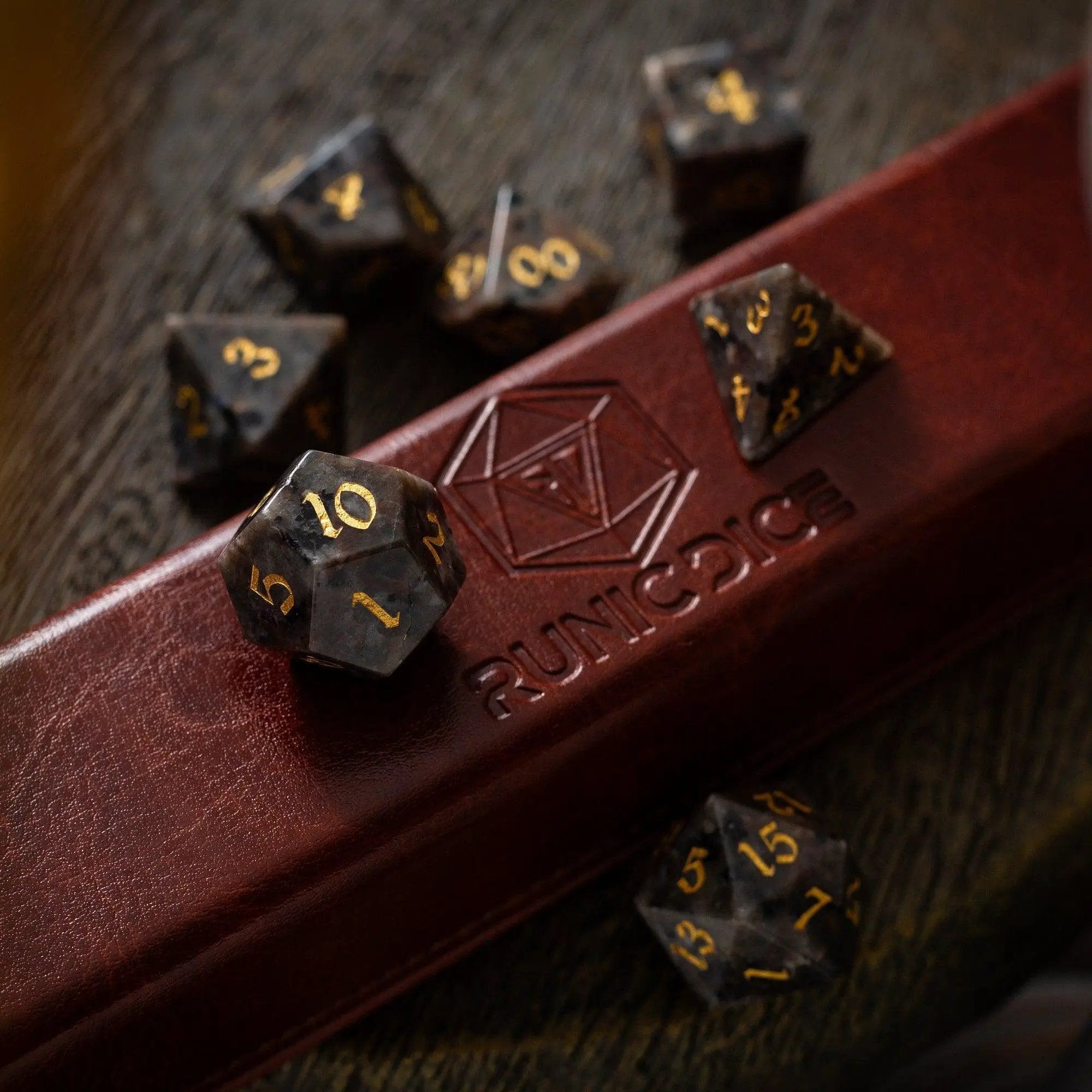 Hand-carved gemstone Yooperlite DND dice set by Runic Dice, featuring vibrant, polished gemstone dice for tabletop gaming.