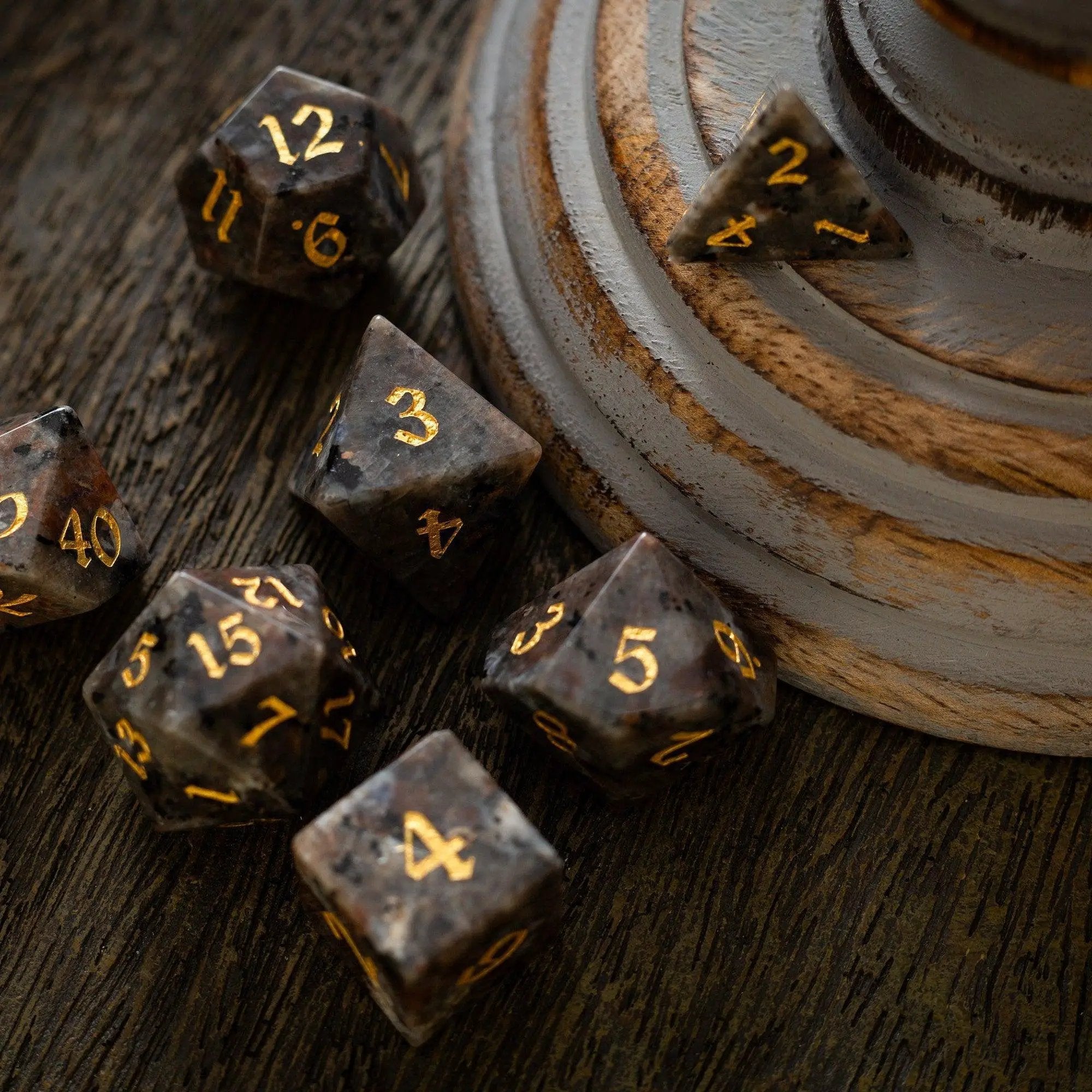 Hand-carved Yooperlite gemstone DND dice set by Runic Dice featuring vibrant, polished gemstone dice for tabletop gaming.