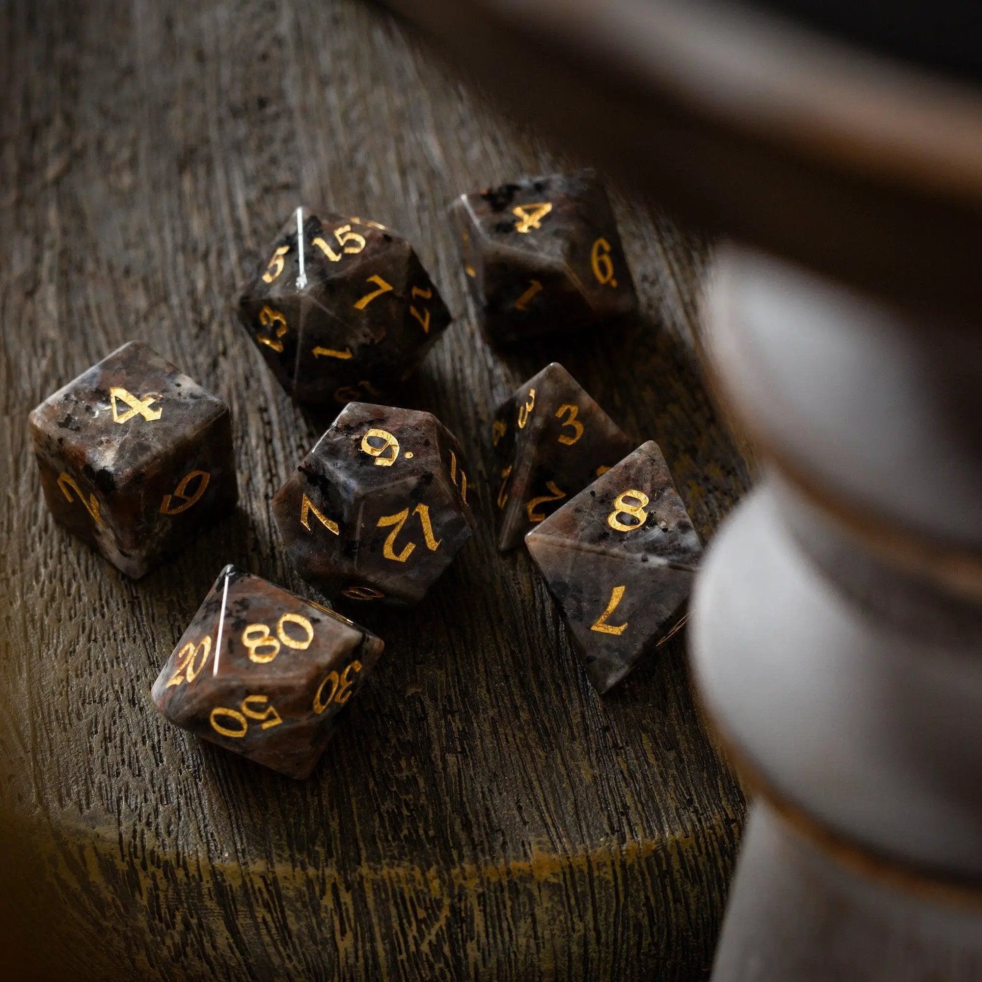 Hand-carved Yooperlite gemstone DND dice set by Runic Dice, featuring vibrant, polished gemstone dice for tabletop gaming.