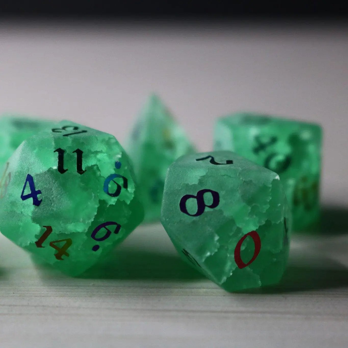 Green mint gemstone DND dice set with lightning crack patterns by Runic Dice, featuring inked numbers and a polished glass finish.