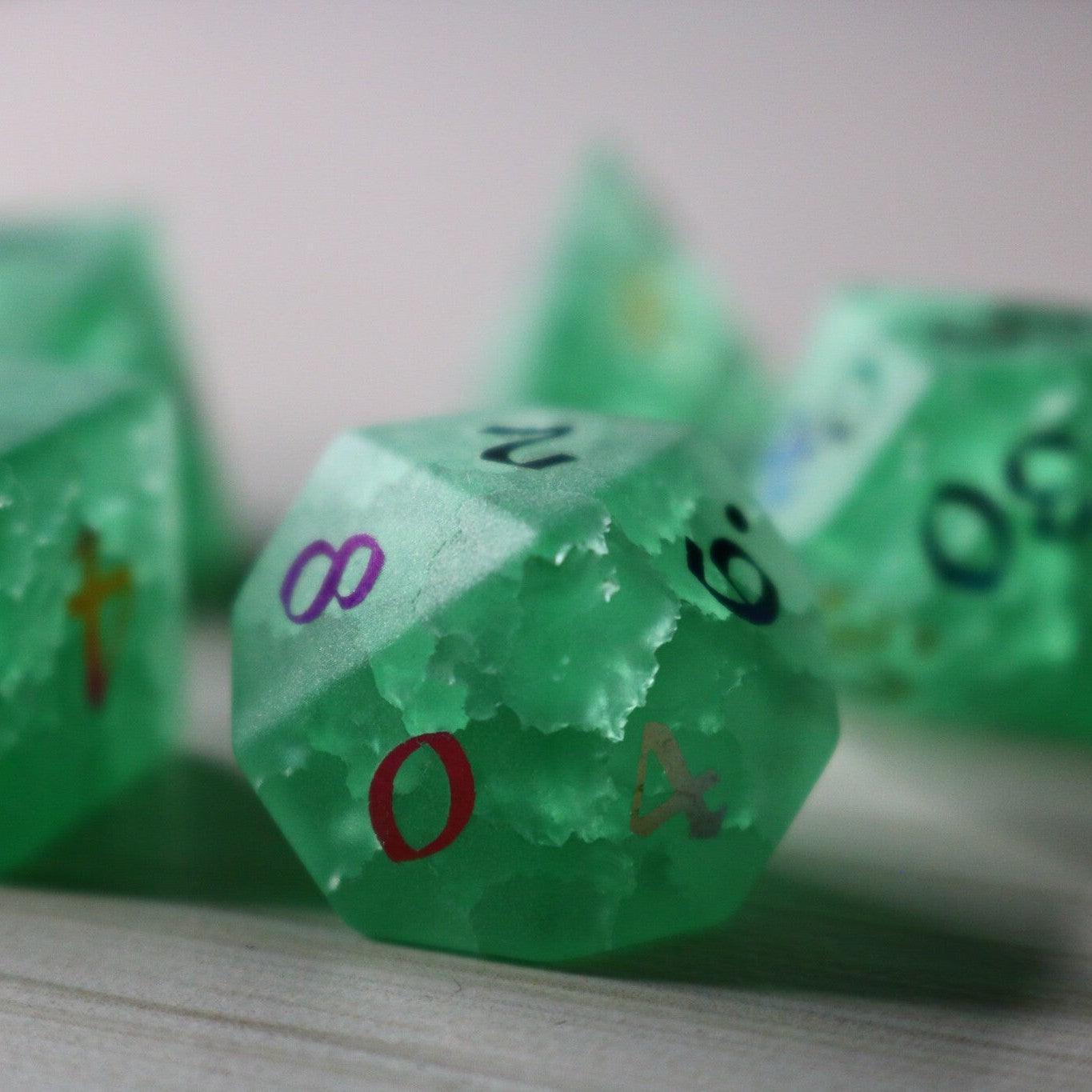 Green mint gemstone DND dice set with lightning crack pattern by Runic Dice, featuring inked numbers and translucent cracked glass design.