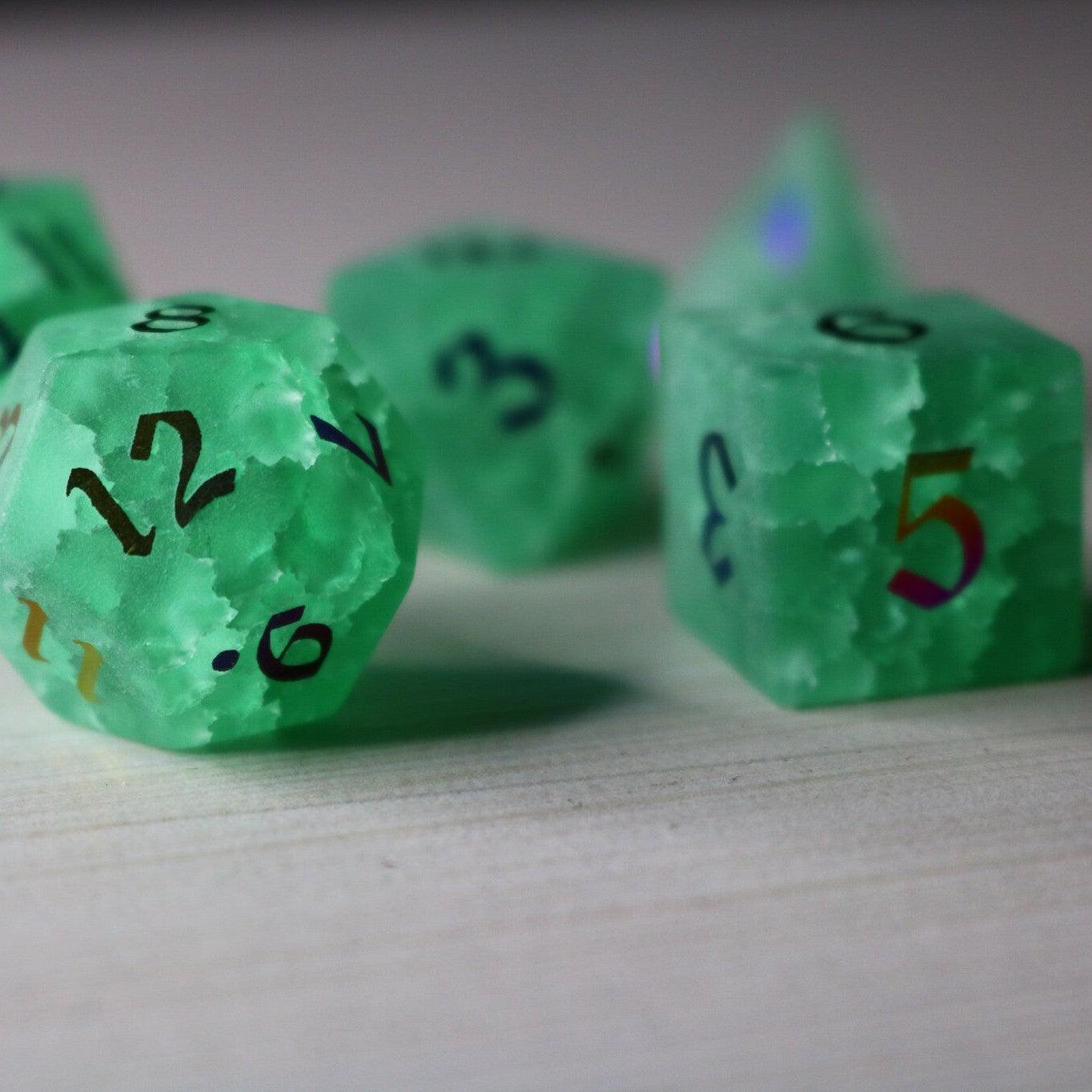 Green mint gemstone DND dice set with lightning crack patterns by Runic Dice, featuring inked numbers and a cracked glass design.
