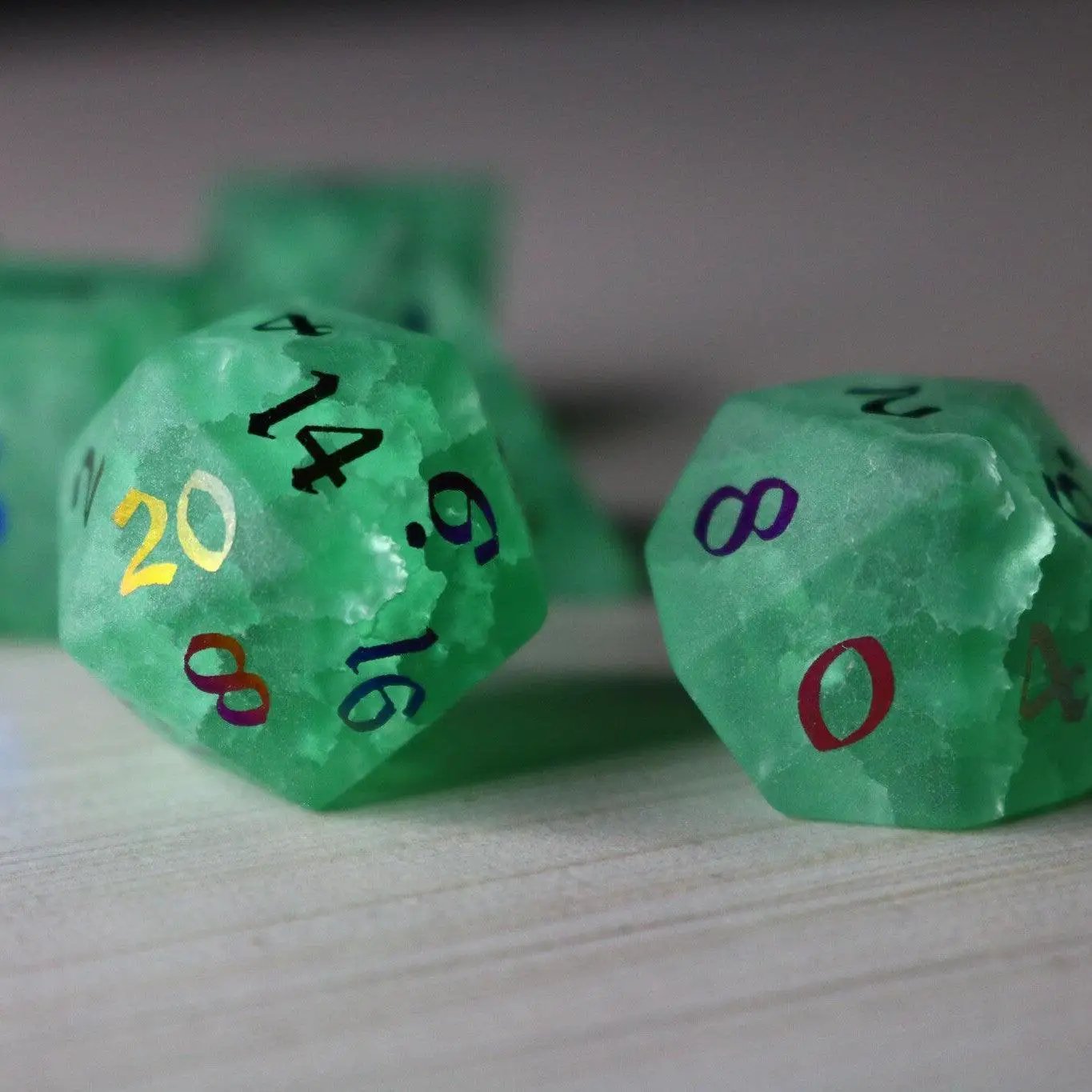 Green mint gemstone DND dice set with lightning crack pattern from Runic Dice, featuring inked numbers and a cracked glass design.