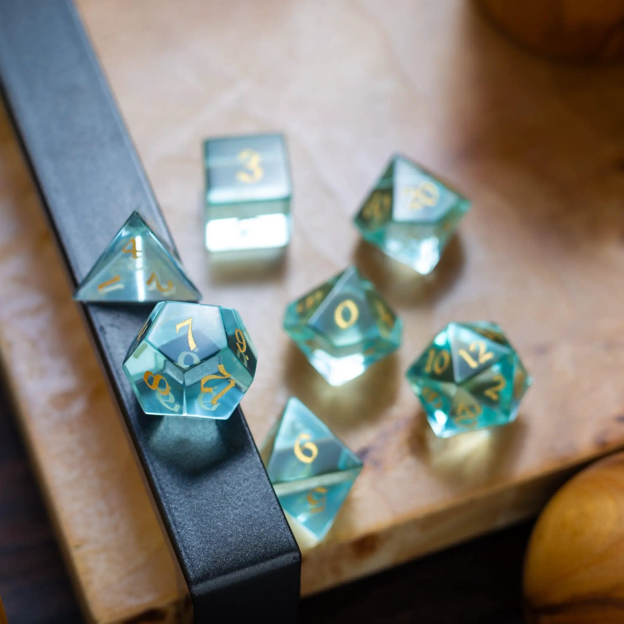 Green water glass gemstone DND dice set with hand-carved numbers from Runic Dice, featuring a vibrant, translucent green appearance.