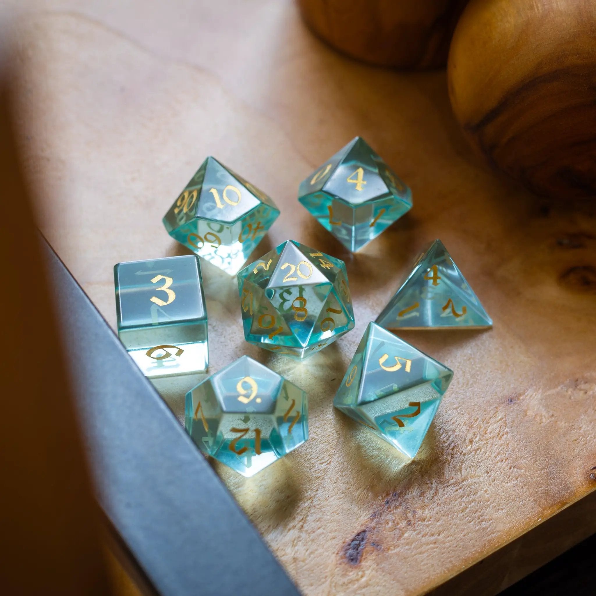 Hand-carved green water glass gemstone dice set for DND by Runic Dice, featuring intricate craftsmanship and vibrant color.