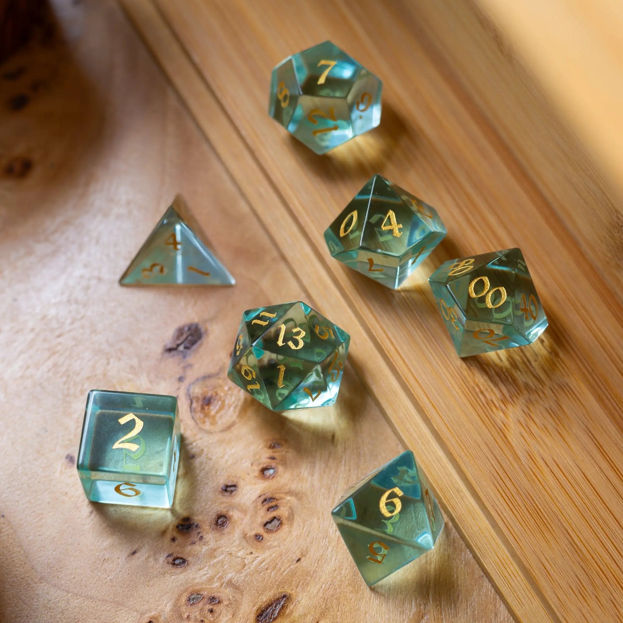 Green water glass gemstone DND dice set with hand-carved numbers by Runic Dice, featuring six polished, vibrant gaming dice.