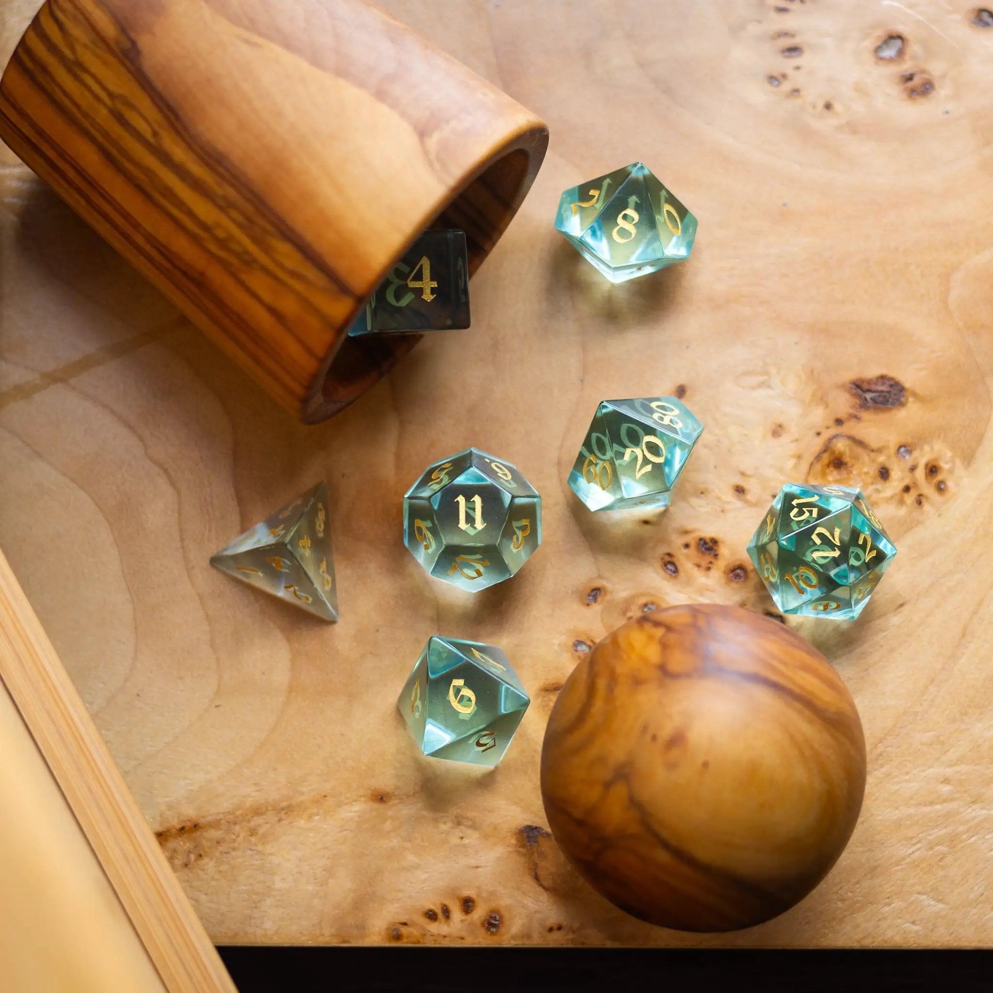 Hand-carved green water glass gemstone DND dice set by Runic Dice, featuring intricate carvings and vibrant green color.