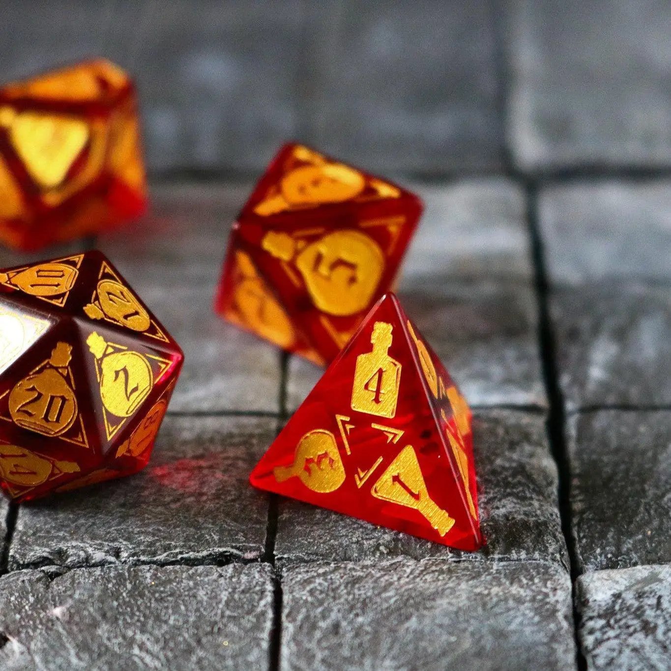 Red zircon gemstone DND dice set by Runic Dice featuring a health potion design, with clear, faceted glass dice for tabletop gaming.