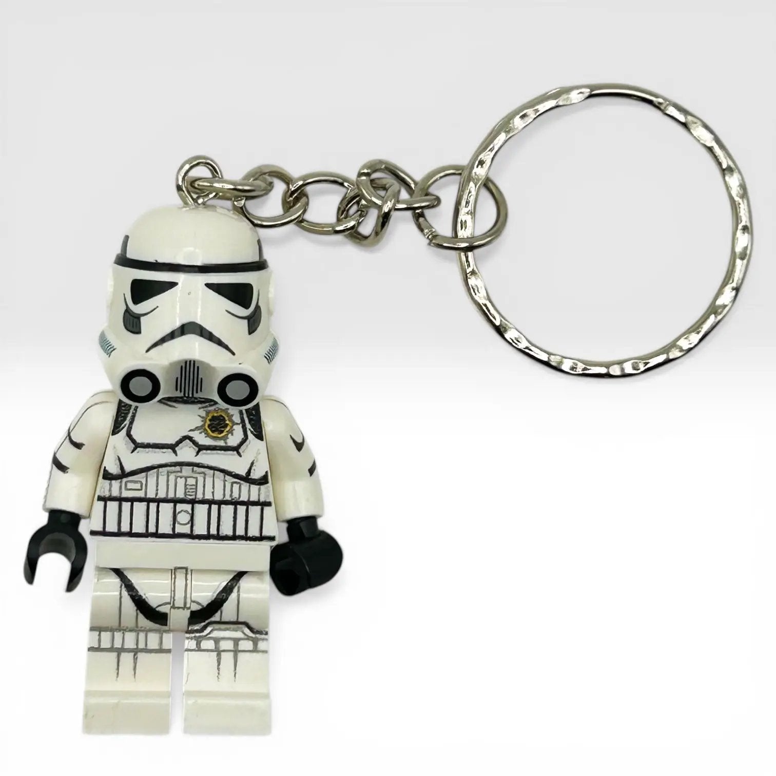 Stormtrooper minifig keychain by B3 Customs featuring a blaster shot design, with detailed plastic figure and keyring attachment.