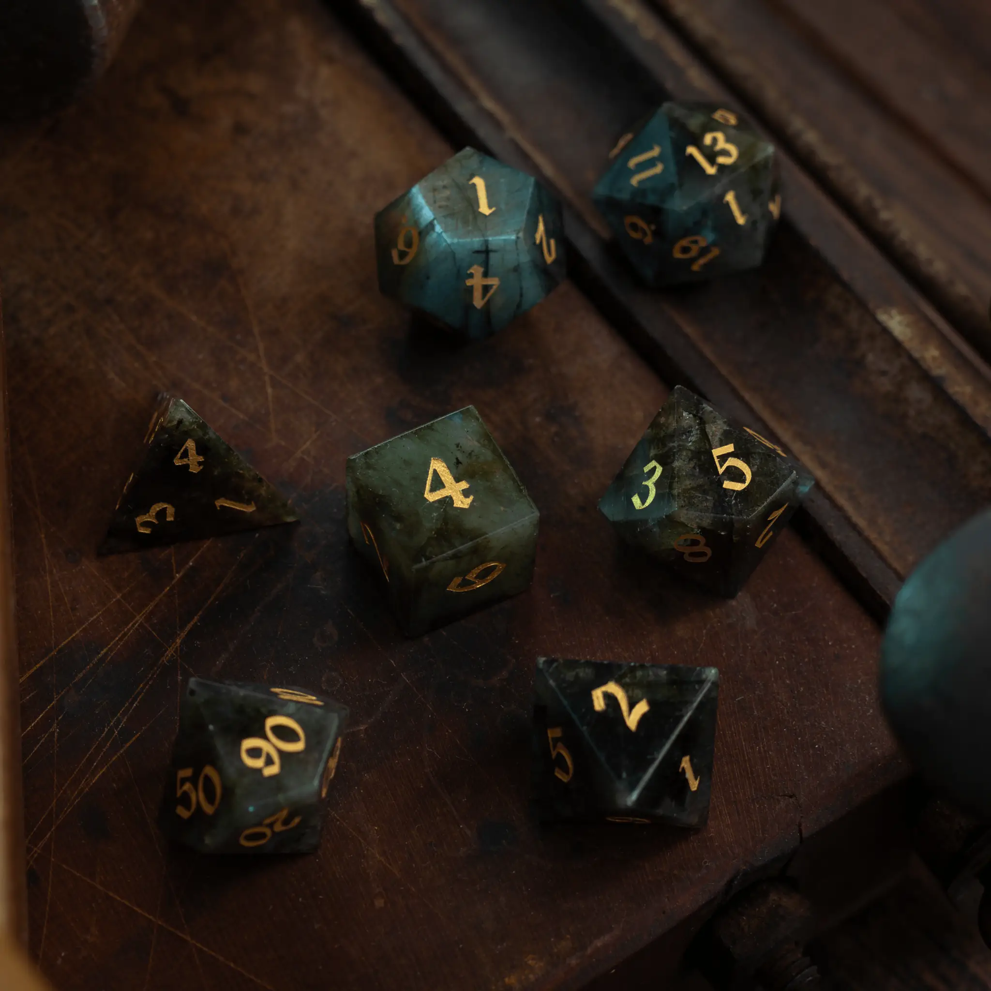 Labradorite gemstone DND dice set by Runic Dice featuring polished, multicolored gemstone polyhedral dice for tabletop gaming.