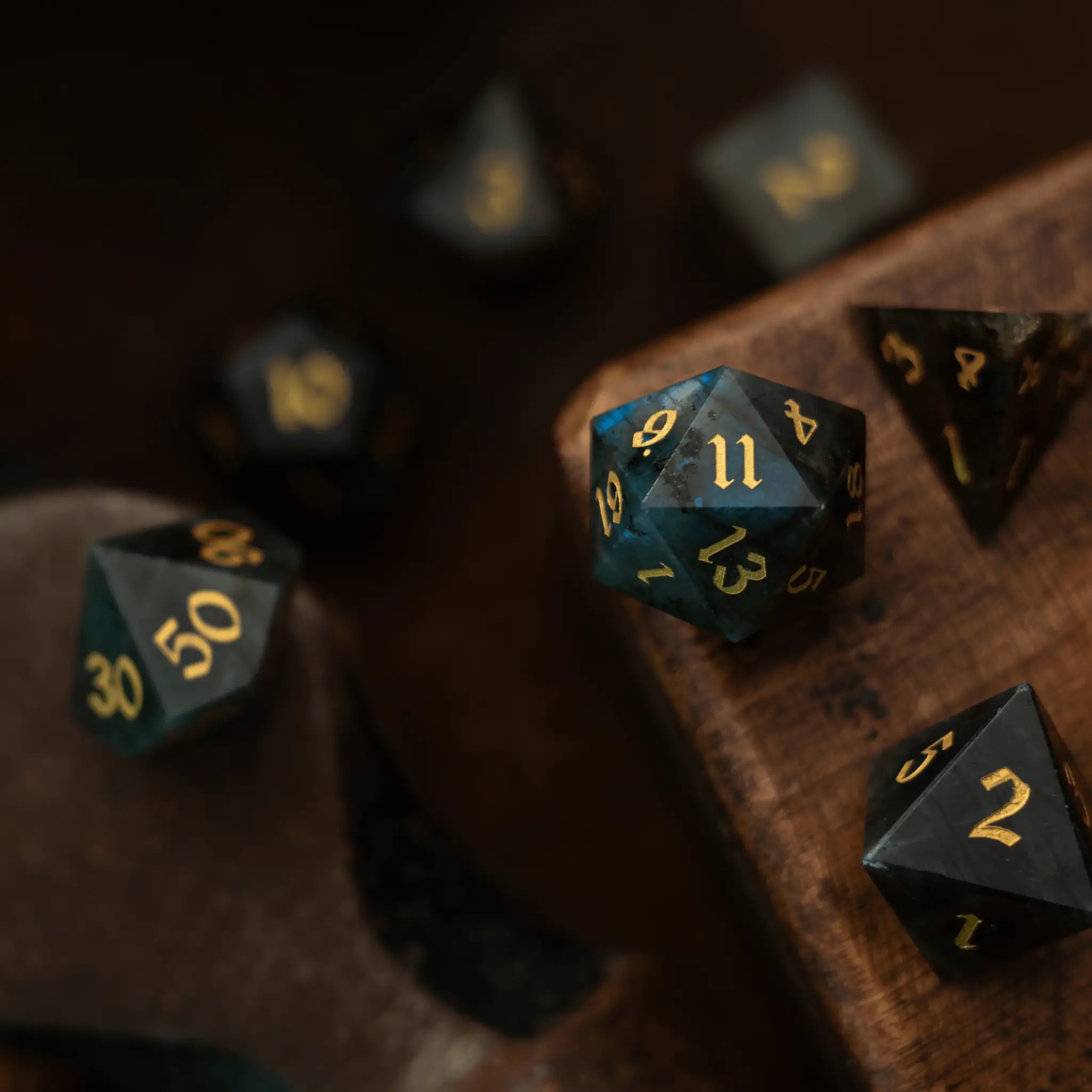 Labradorite gemstone DND dice set by Runic Dice, featuring polished, multicolored gemstone dice with intricate carvings for tabletop gaming.