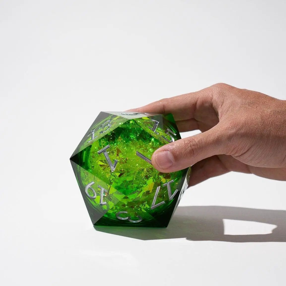 Green resin chonk dice with liquid core, handmade by Runic Dice, shown with its storage box in the image.
