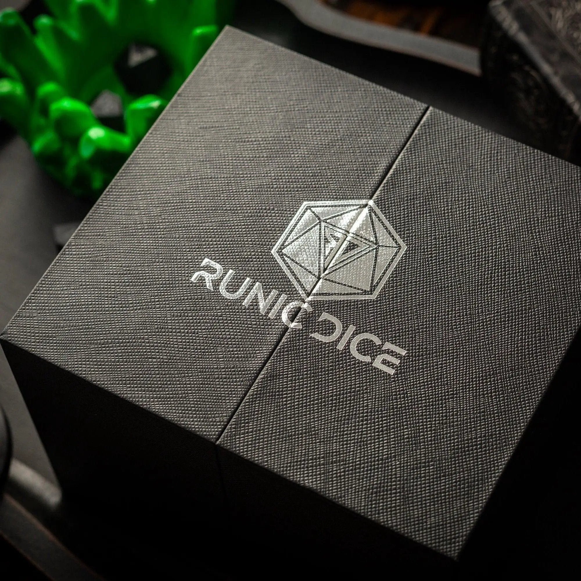 Green Resin Chonk dice with skull design and liquid core, handmade by Runic Dice, displayed with its box.