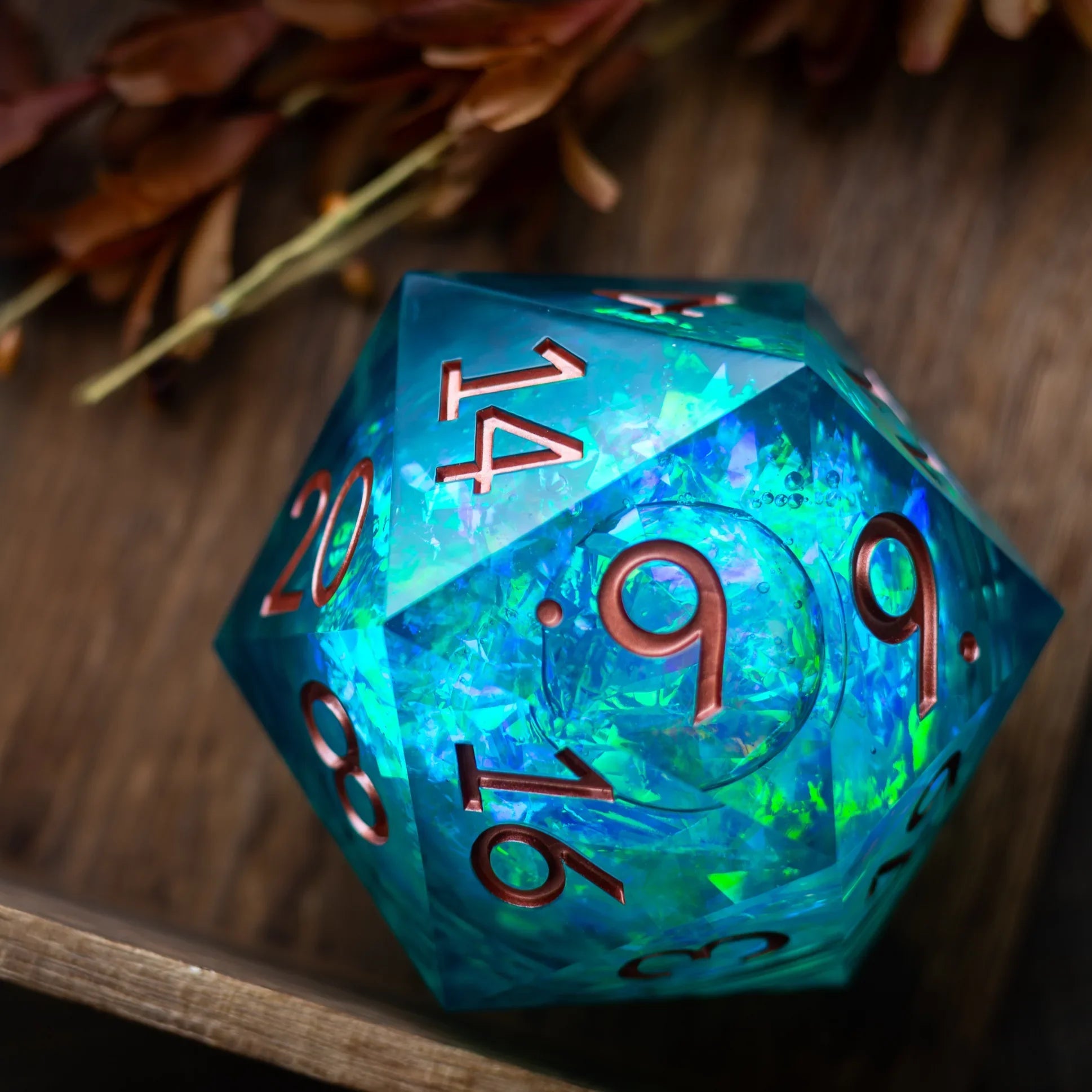 Sea green teal resin chonk dice with liquid core, handmade by Runic Dice, displayed with its matching storage box.