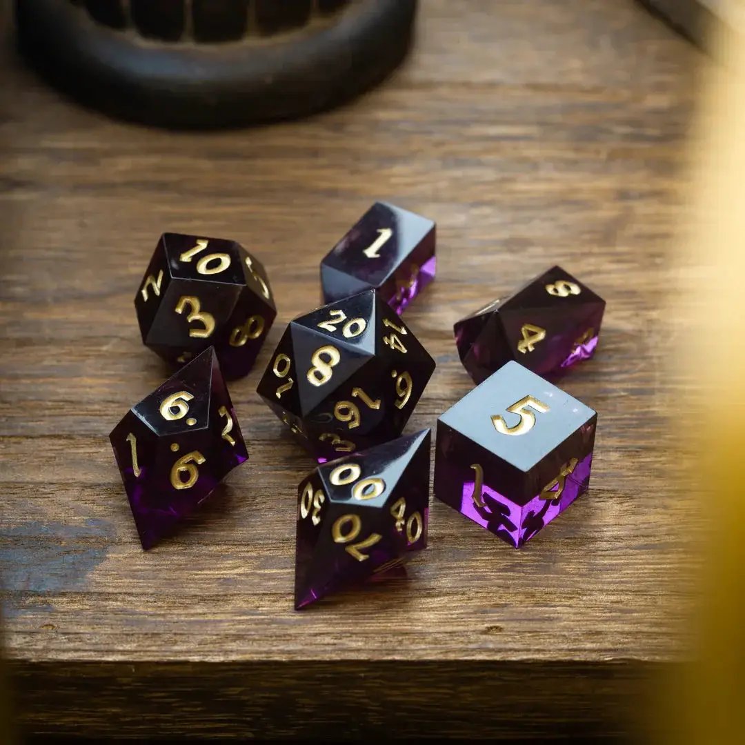Mystic violet resin DND dice set by Runic Dice, featuring various polyhedral dice with a swirling violet design.