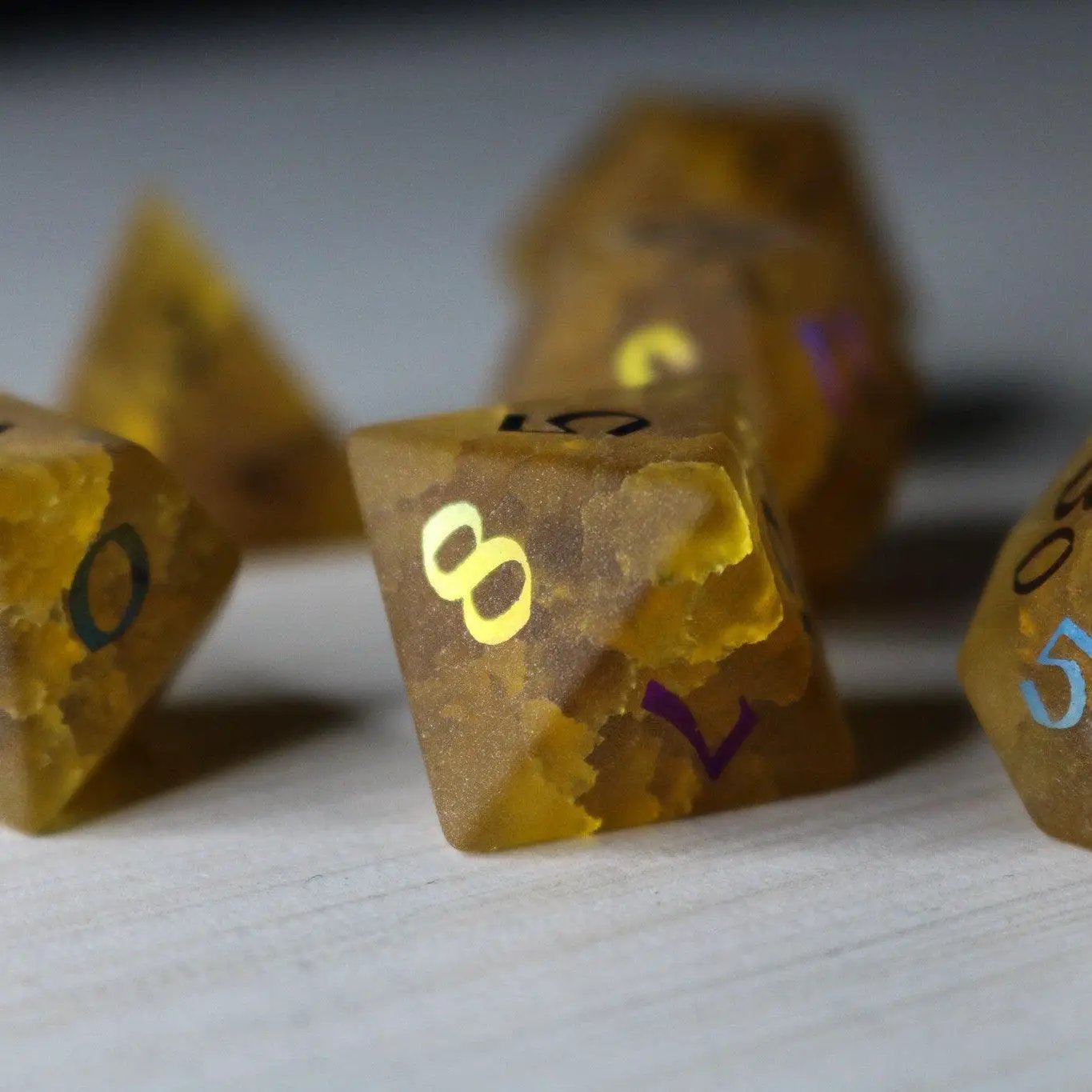 Orange Halloween pumpkin inked gemstone DND dice set by Runic Dice featuring lightning crack design, perfect for tabletop gaming.