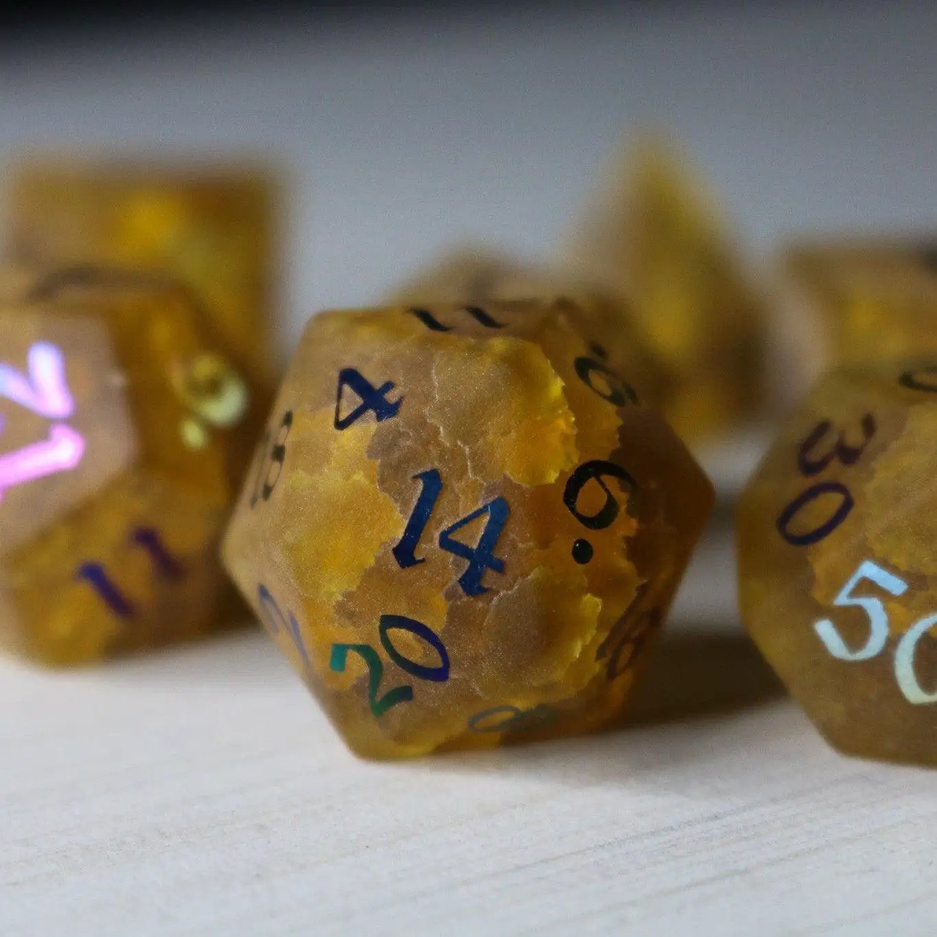 Orange Halloween pumpkin gemstone DND dice set with lightning-inked cracked glass design by Runic Dice.