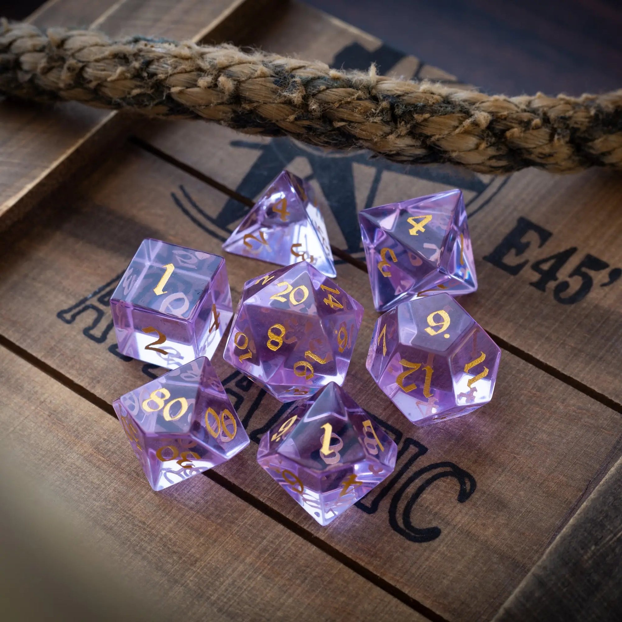 Purple zircon glass gemstone D&D dice set hand-carved by Runic Dice, featuring detailed designs and vibrant purple color.