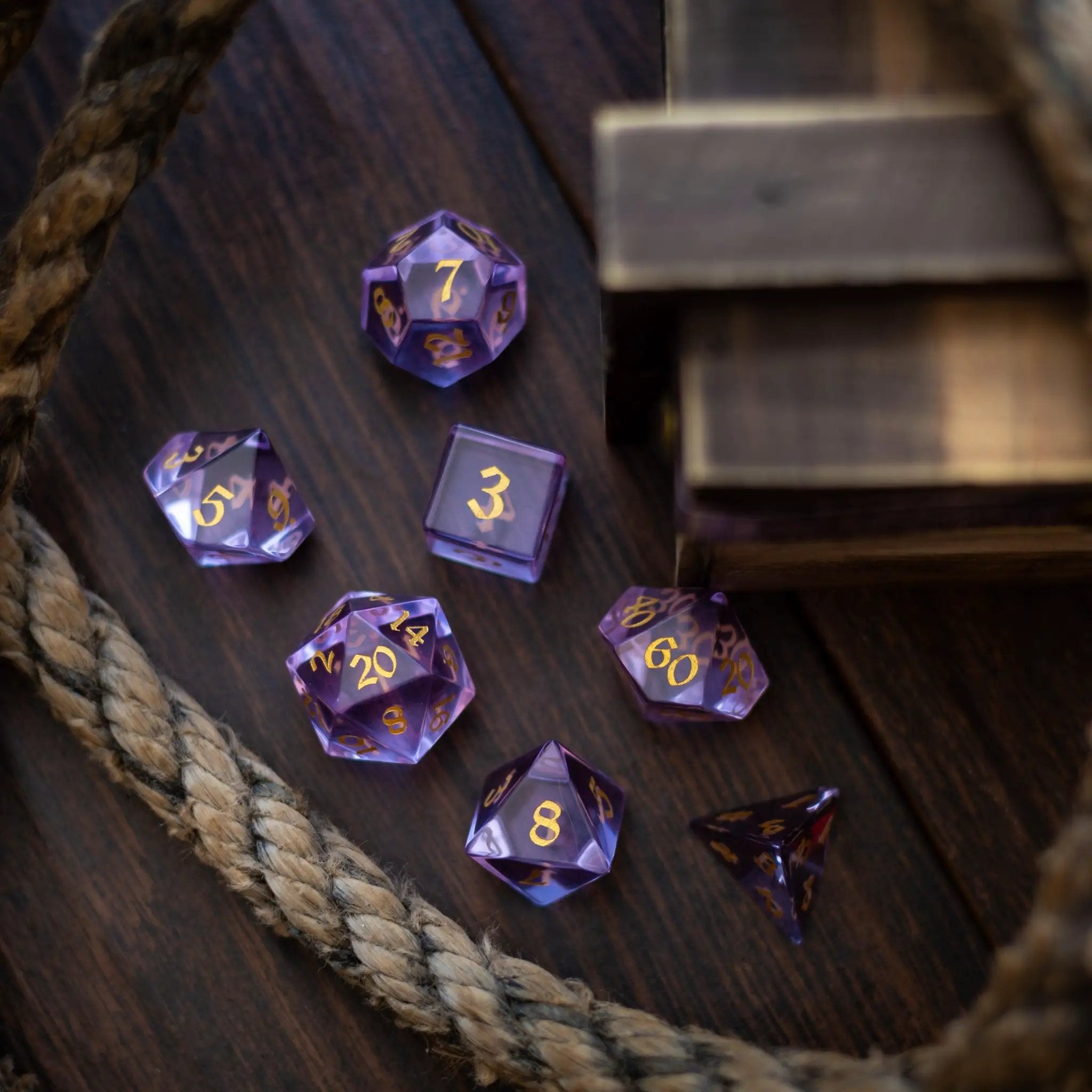 Purple zircon glass gemstone D&D dice set by Runic Dice, hand-carved with intricate details for tabletop gaming.