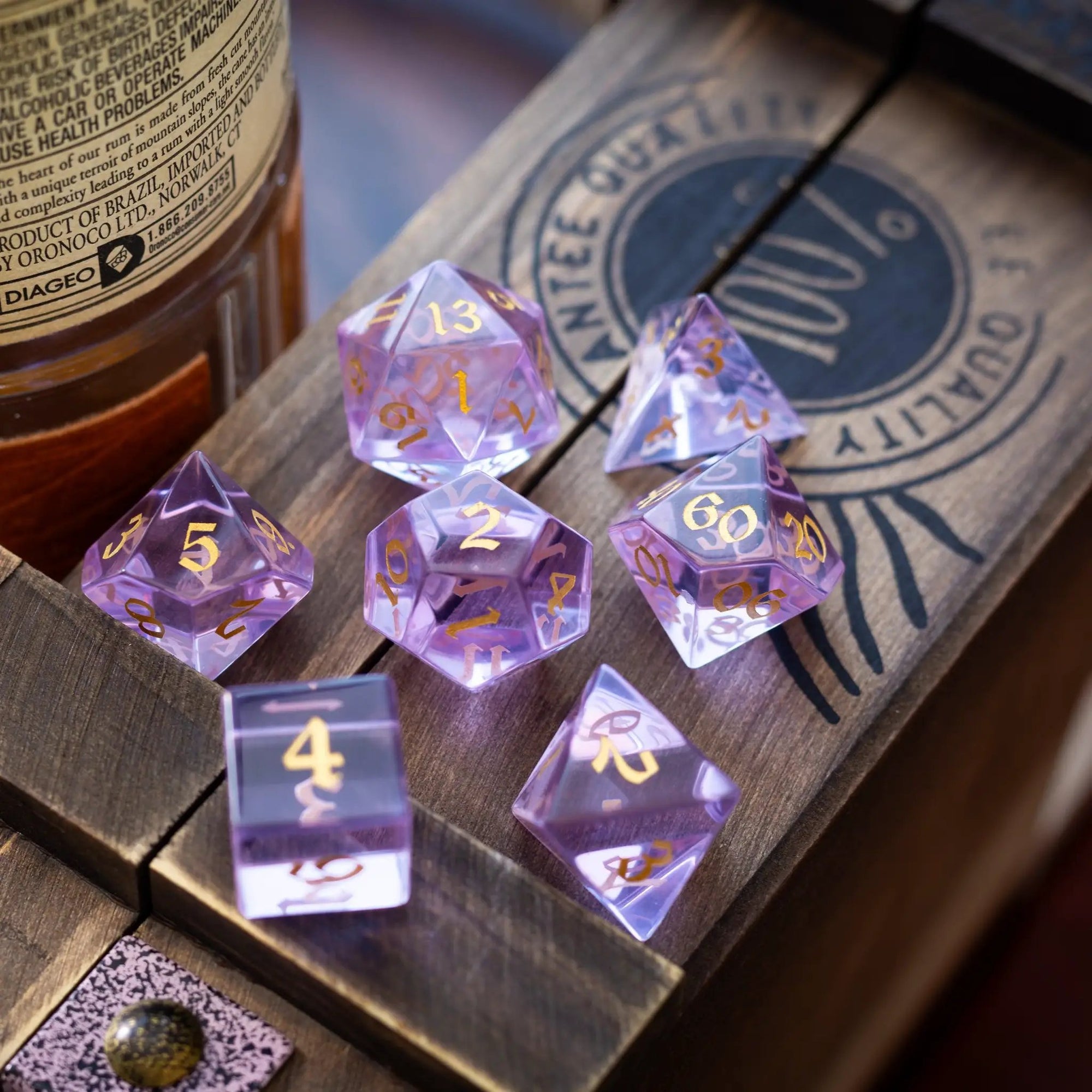 Purple zircon gemstone DND dice set by Runic Dice, hand-carved glass dice with a vibrant purple color and intricate detailing.