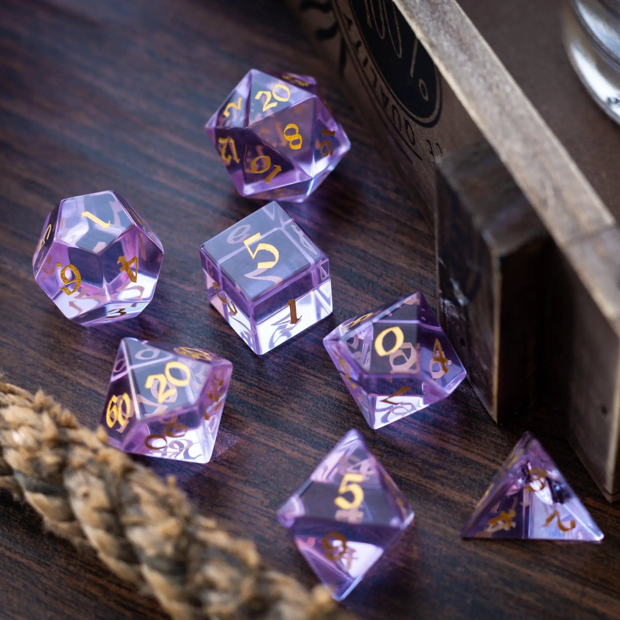 Purple zircon glass gemstone dice set by Runic Dice featuring hand-carved D&D polyhedral dice for tabletop gaming.