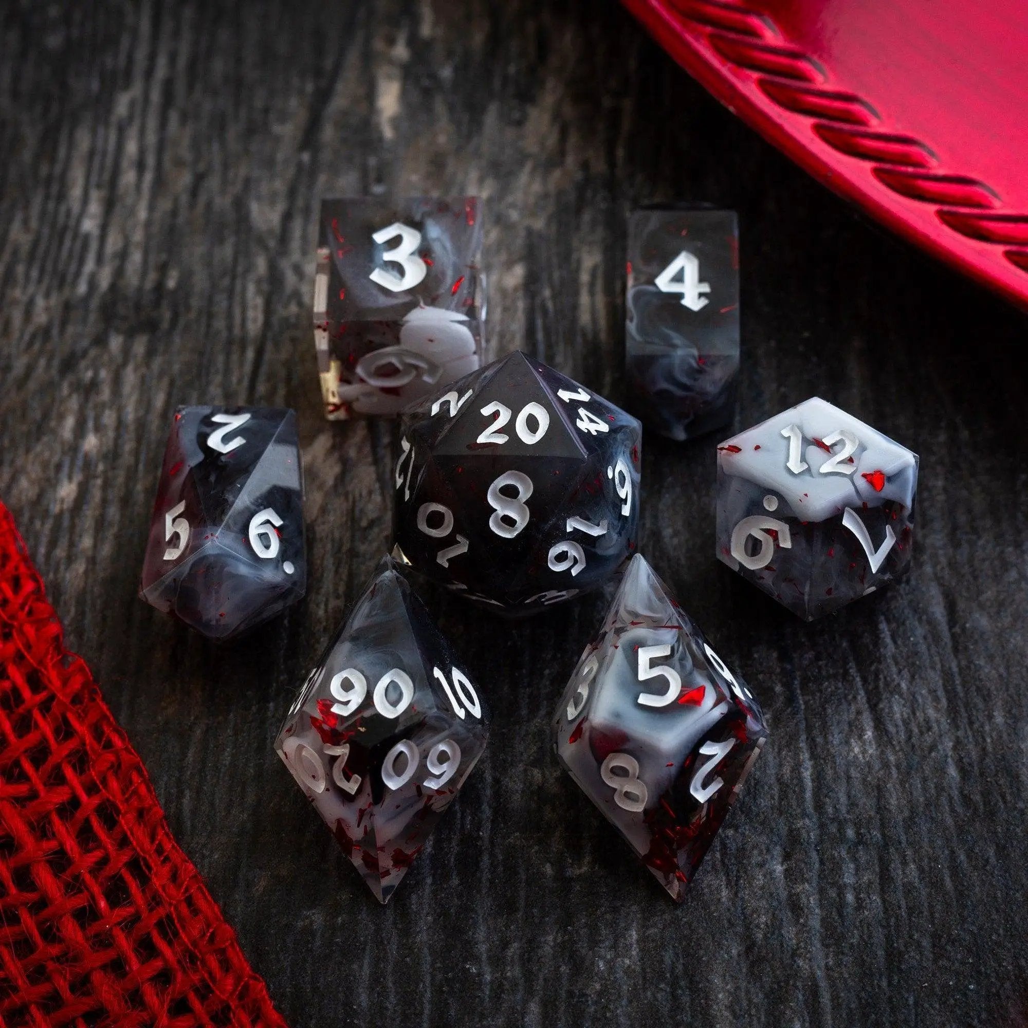 Smoke and Blood handmade resin D&D dice set by Runic Dice, featuring dark, swirling designs perfect for tabletop gaming.