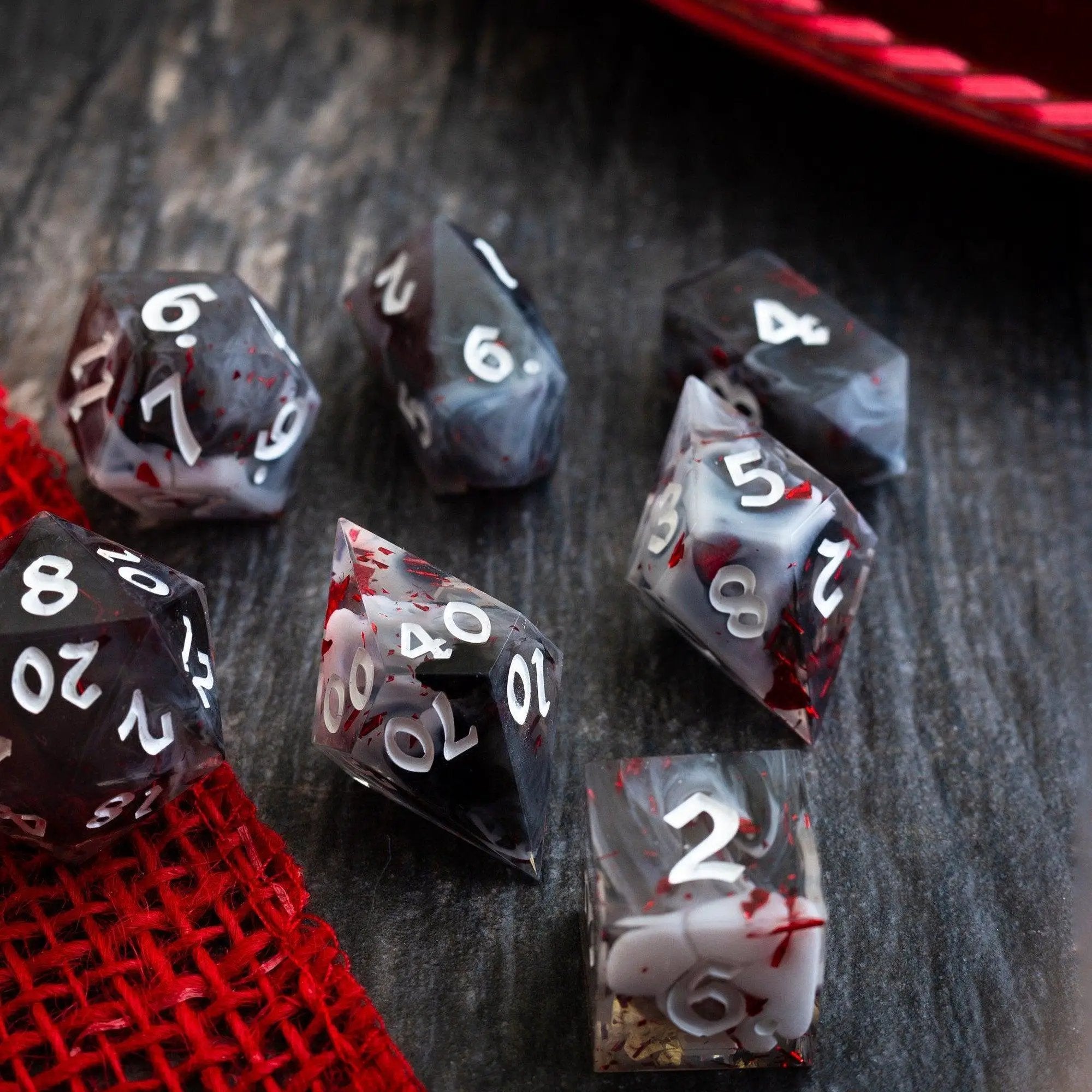 Handmade resin D&D dice set with smoke and blood design by Runic Dice, featuring detailed, colorful gaming dice for tabletop role-playing.