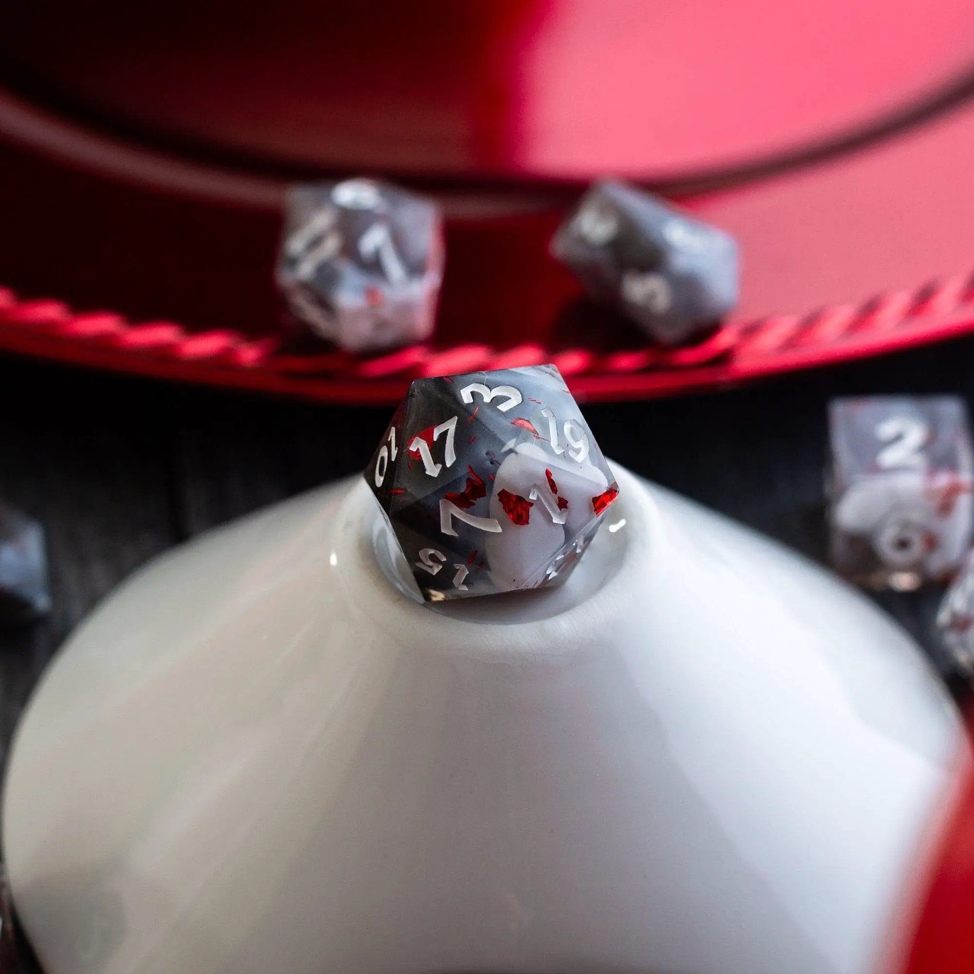 Smoke and Blood handmade resin DND dice set by Runic Dice featuring dark, smoky and blood-red colored polyhedral gaming dice.