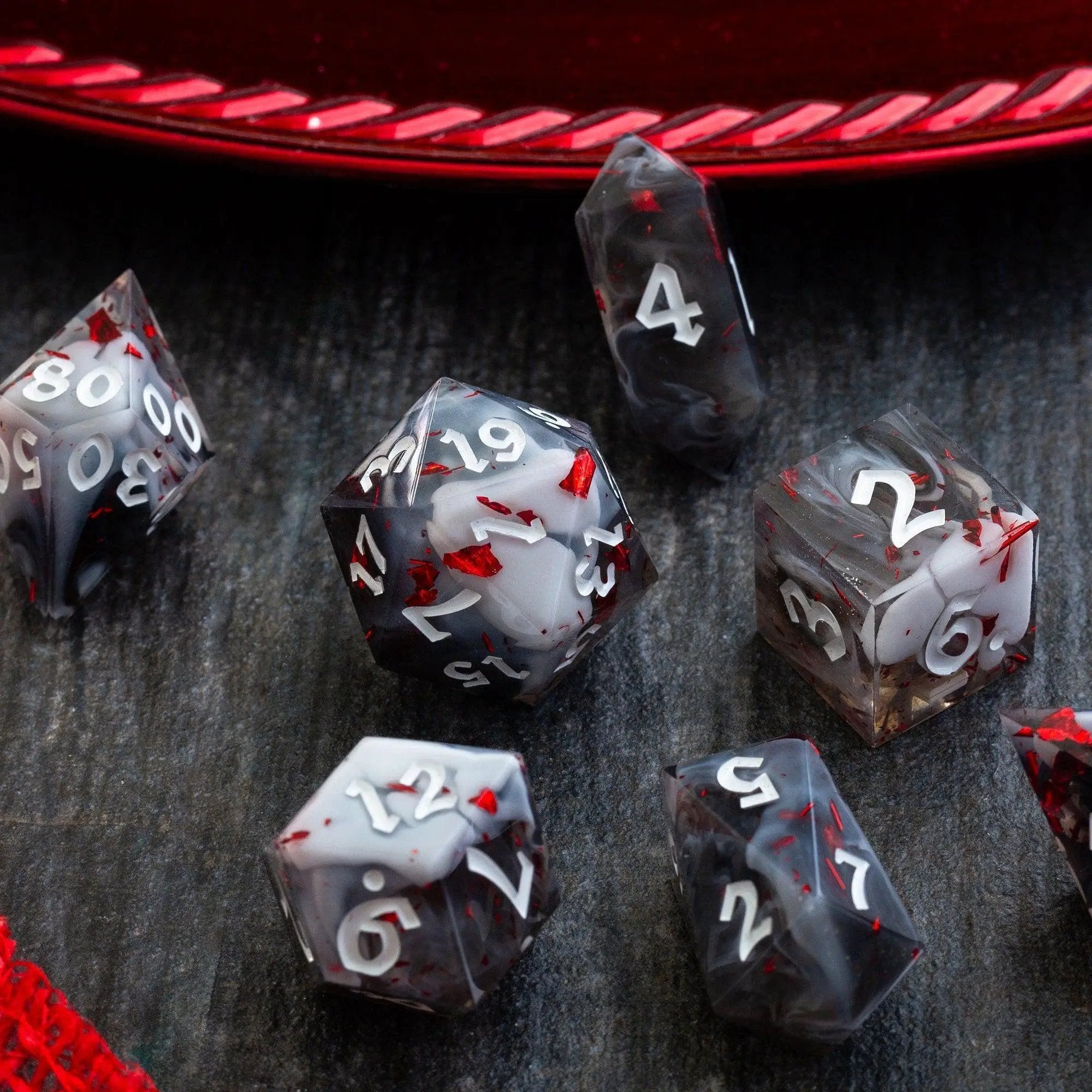 Smoke and Blood handmade resin DND dice set by Runic Dice, featuring dark, smoky colors and intricate blood-red accents.