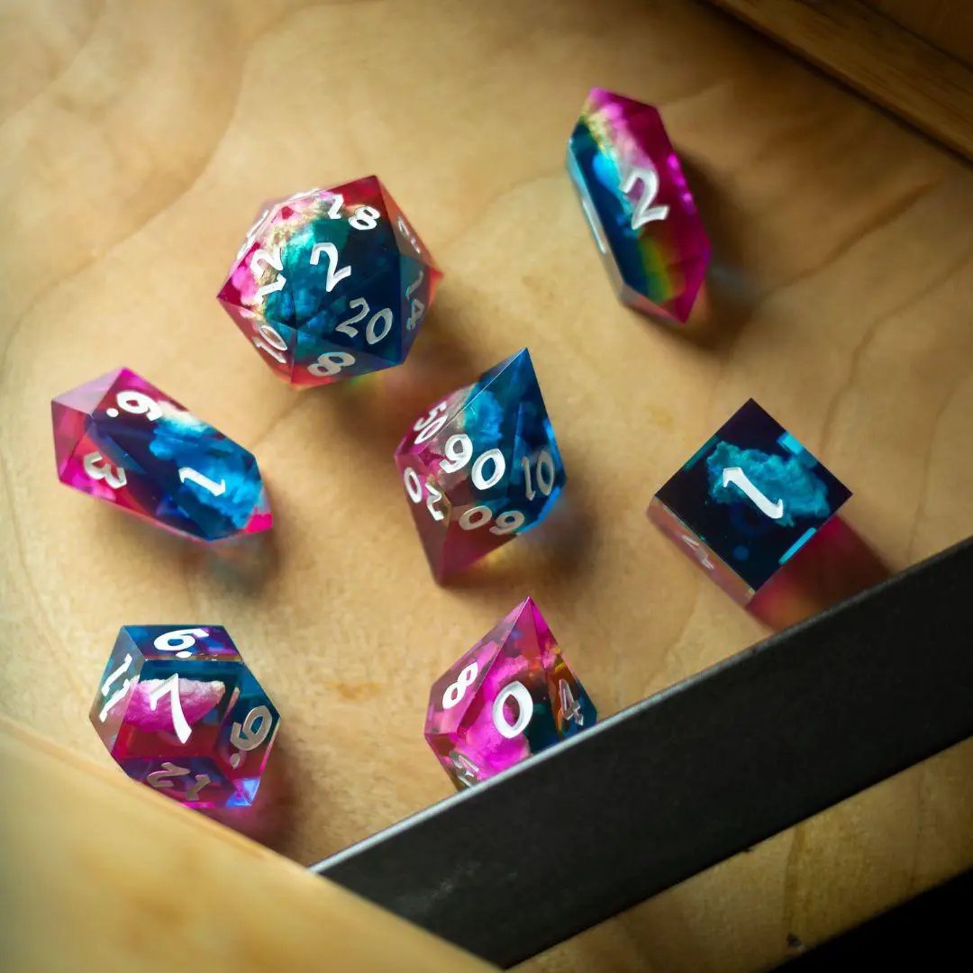Runic Dice Starlit Rift resin DND dice set with shimmering galaxy-inspired designs on black and purple dice.