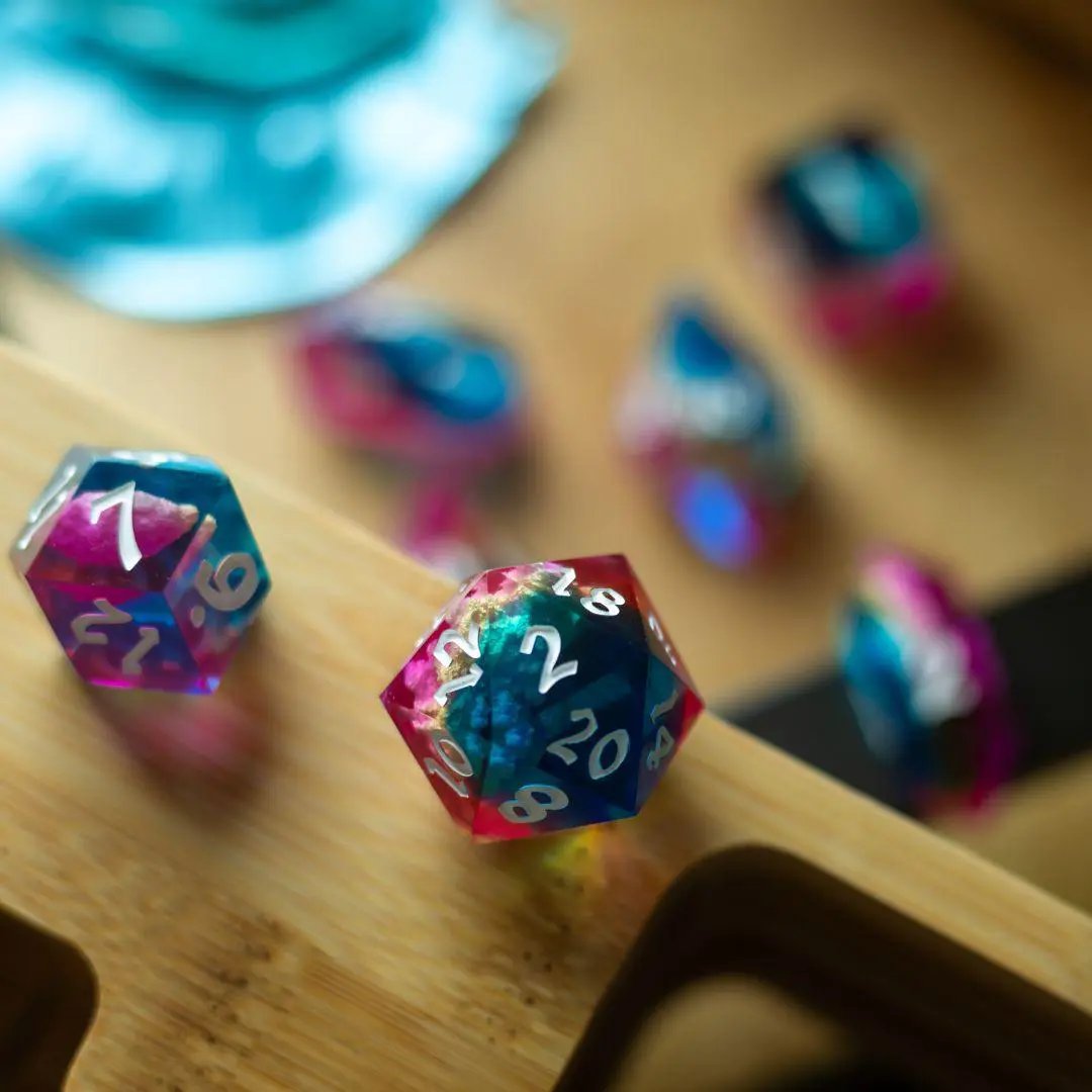 Set of Starlit Rift resin DND dice by Runic Dice, featuring shimmering galaxy-inspired designs and six dice in various shapes.