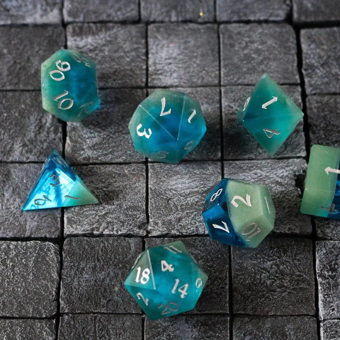 Runic Dice synthetic gemstone two-tone blue and green hand-carved DND dice set featuring six-sided gemstone gaming dice.