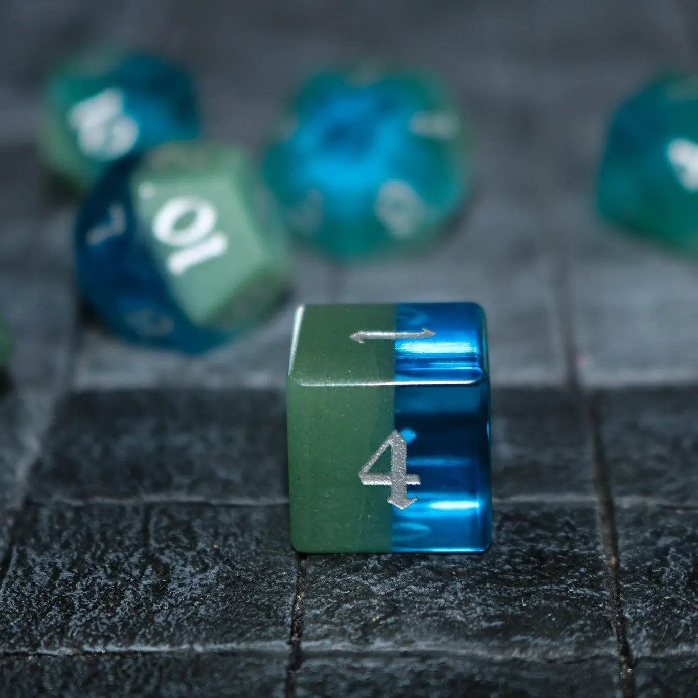 Runic Dice synthetic gemstone two-tone blue and green hand-carved DND dice set, showcasing detailed craftsmanship and vibrant colors.