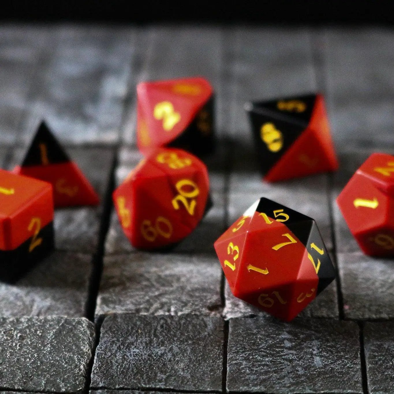 Runic Dice synthetic gemstone two-tone red and black hand-carved DND dice set showing detailed craftsmanship.