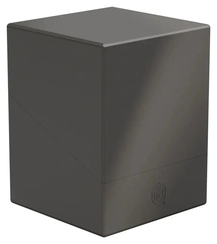 Clear plastic storage case for trading cards, labeled "Ultimate Guard Boulder 100+ Solid," with a transparent cover and sturdy design.