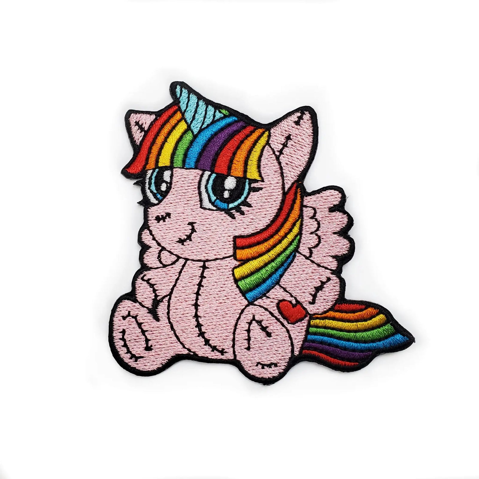 Colorful plush unicorn patch with rainbow accents by Kolorspun, featuring soft fabric and detailed embroidery.