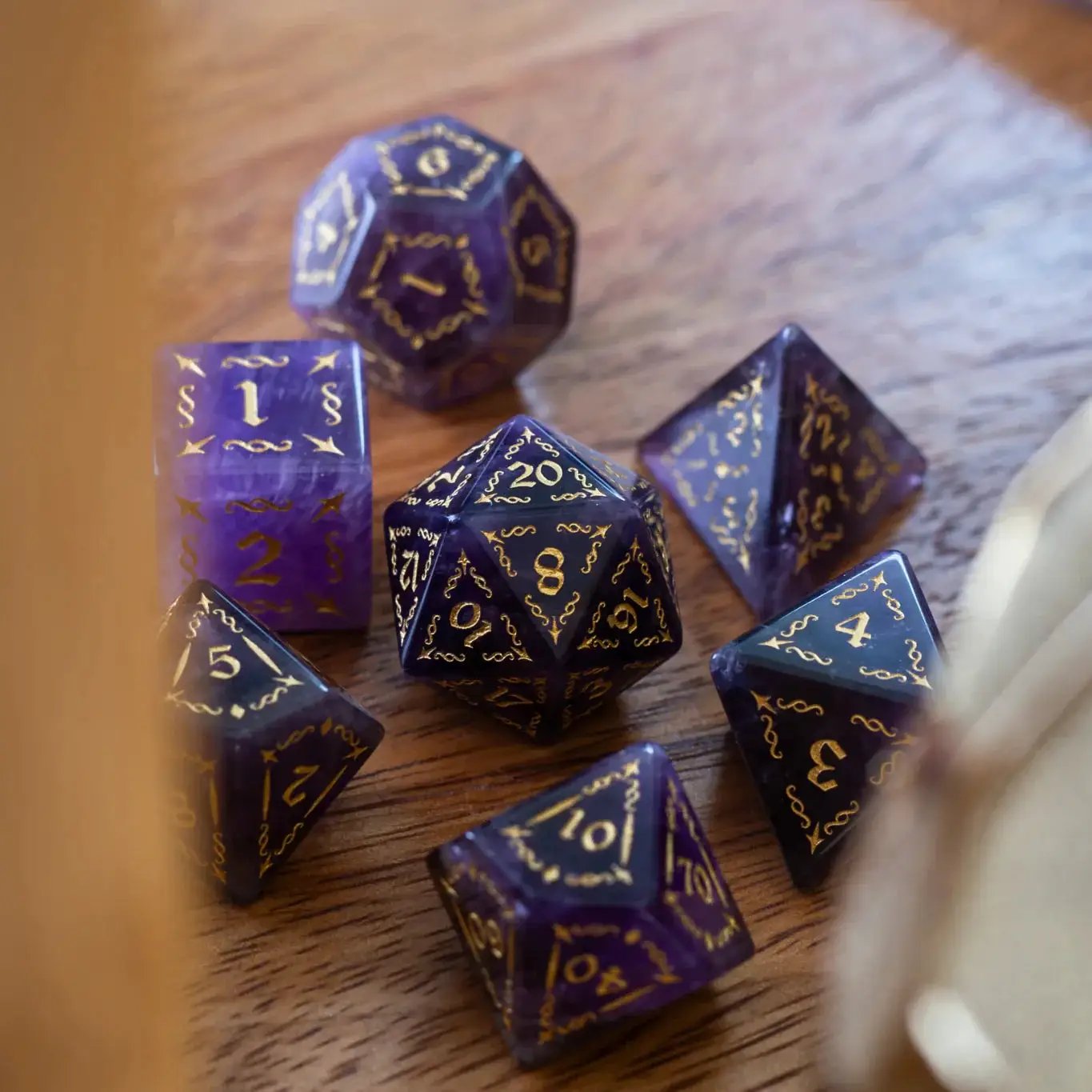 Purple amethyst gemstone DND dice set with vine spike design by Runic Dice, featuring intricately carved, vibrant gemstone dice.