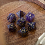 Vine Spike gemstone purple amethyst D&D dice set by Runic Dice with seven polished gemstone dice on a neutral background.