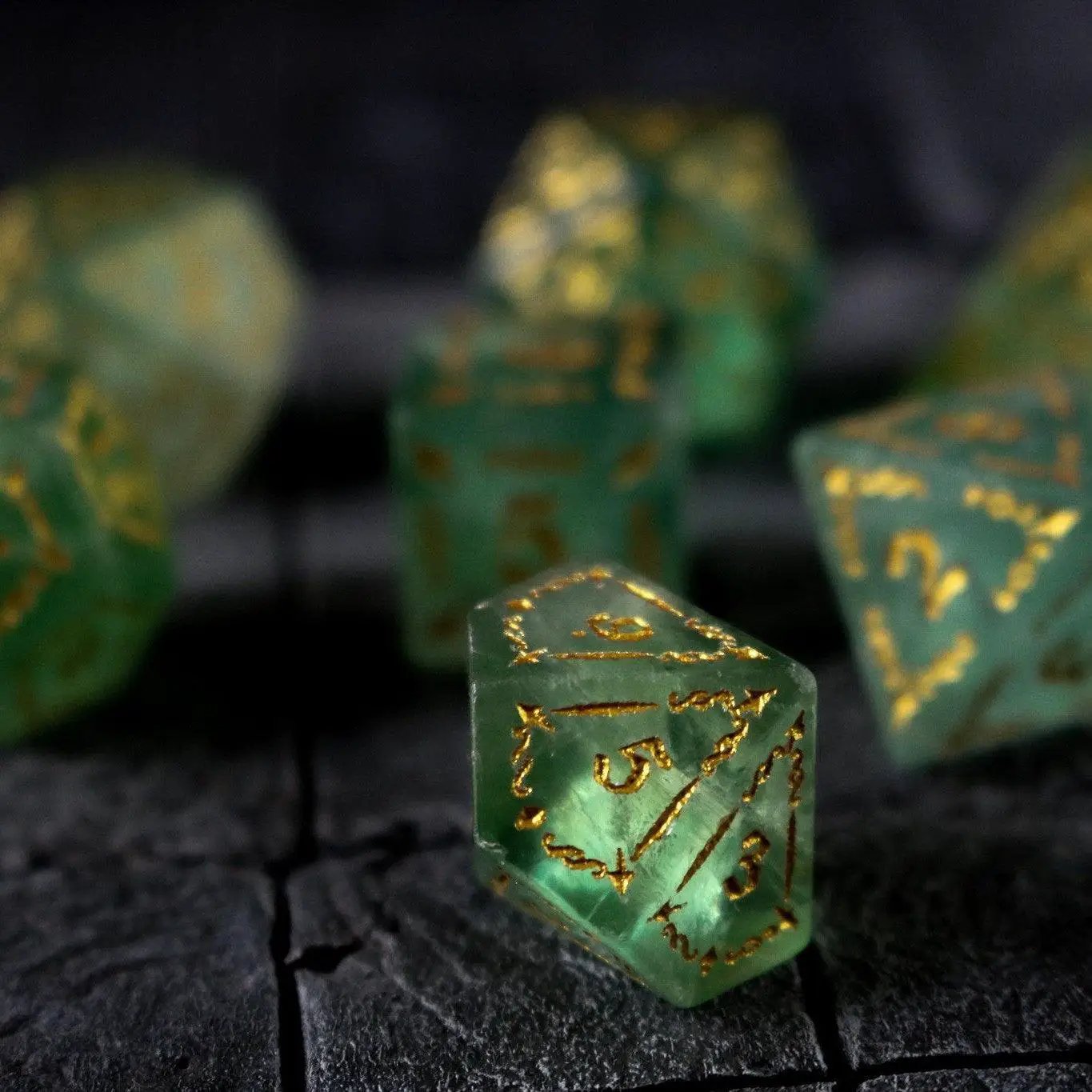 Green fluorite gemstone DND dice set with vine spike design by Runic Dice, featuring polished, colorful gemstone dice for tabletop gaming.