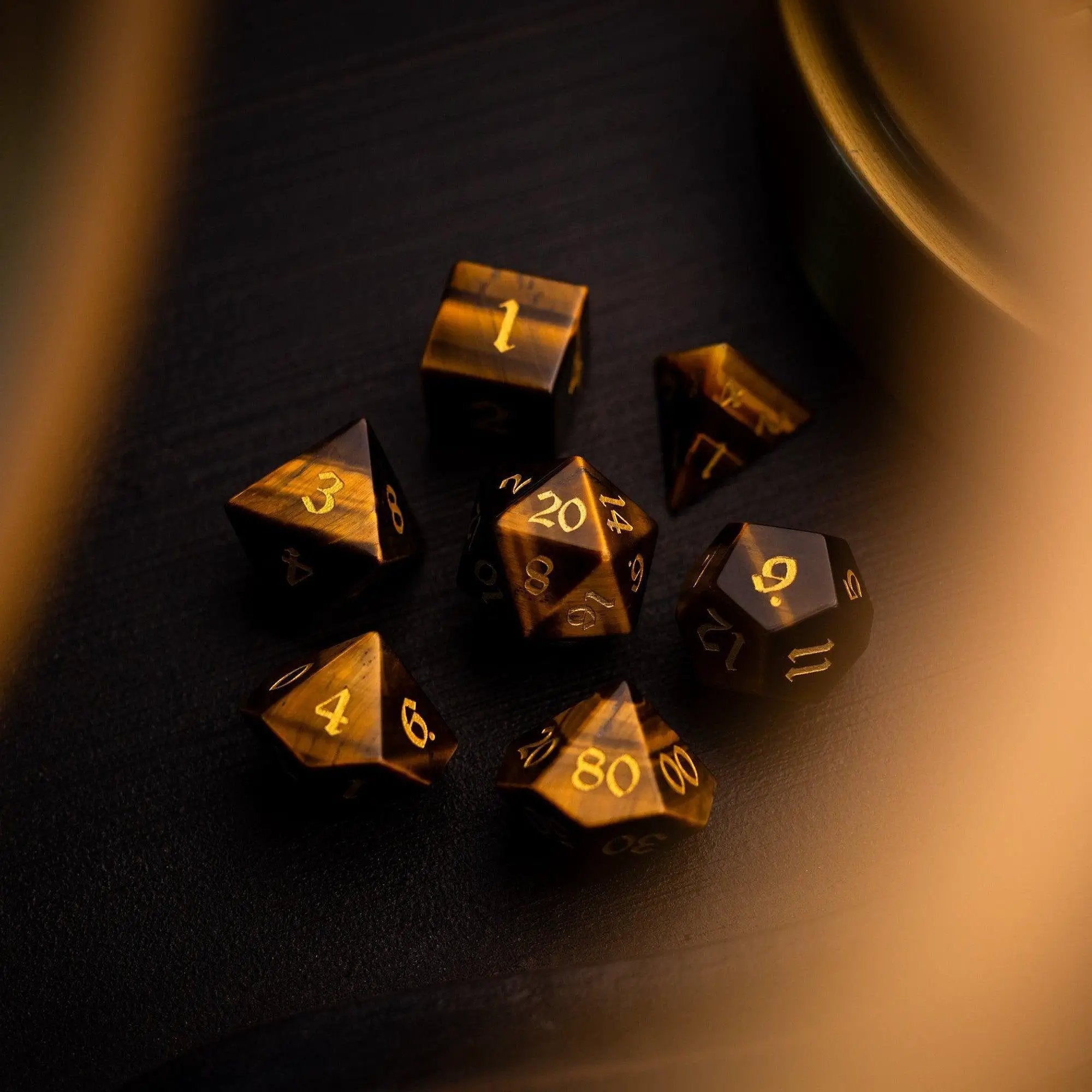 Yellow Tigers Eye gemstone DND dice set by Runic Dice, featuring polished, multi-sided dice for tabletop gaming.