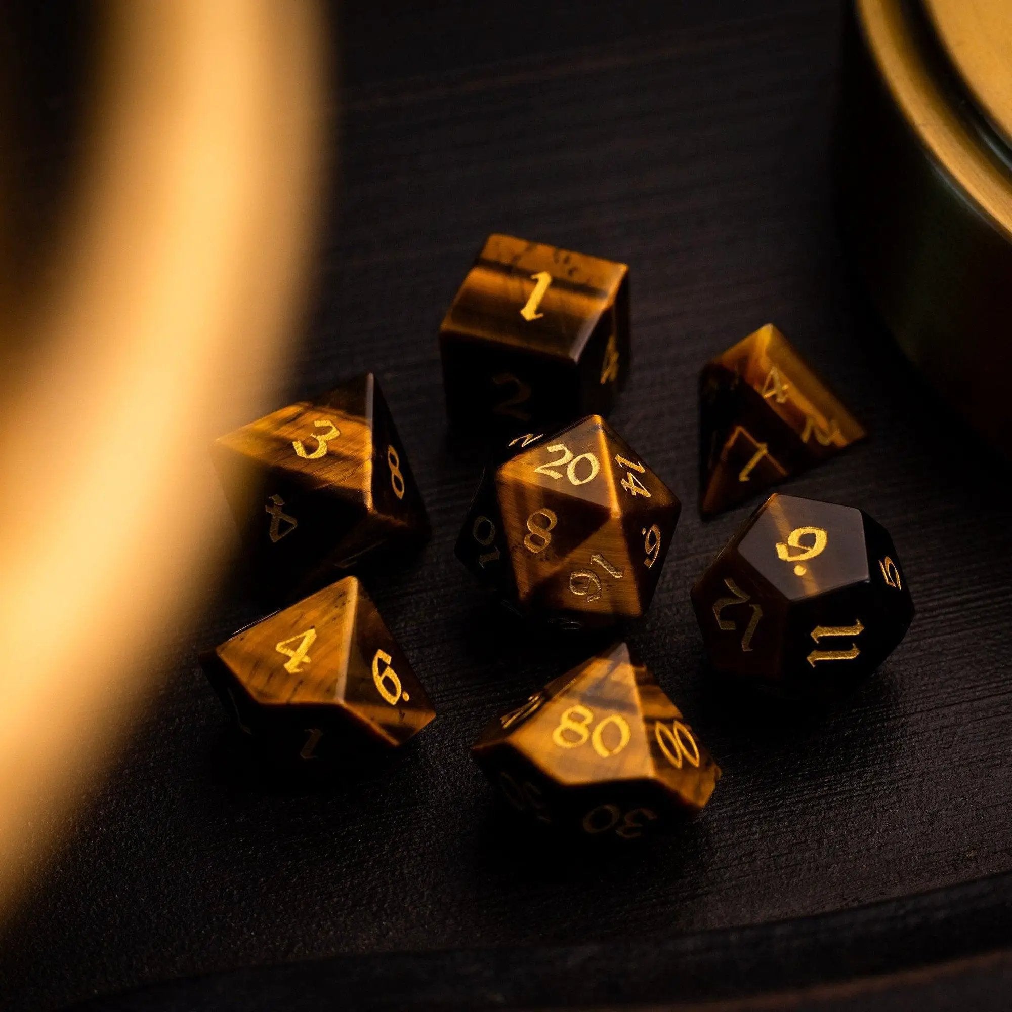 Yellow Tigers Eye gemstone DND dice set by Runic Dice, featuring polished, mult-sided gemstone dice for tabletop gaming.