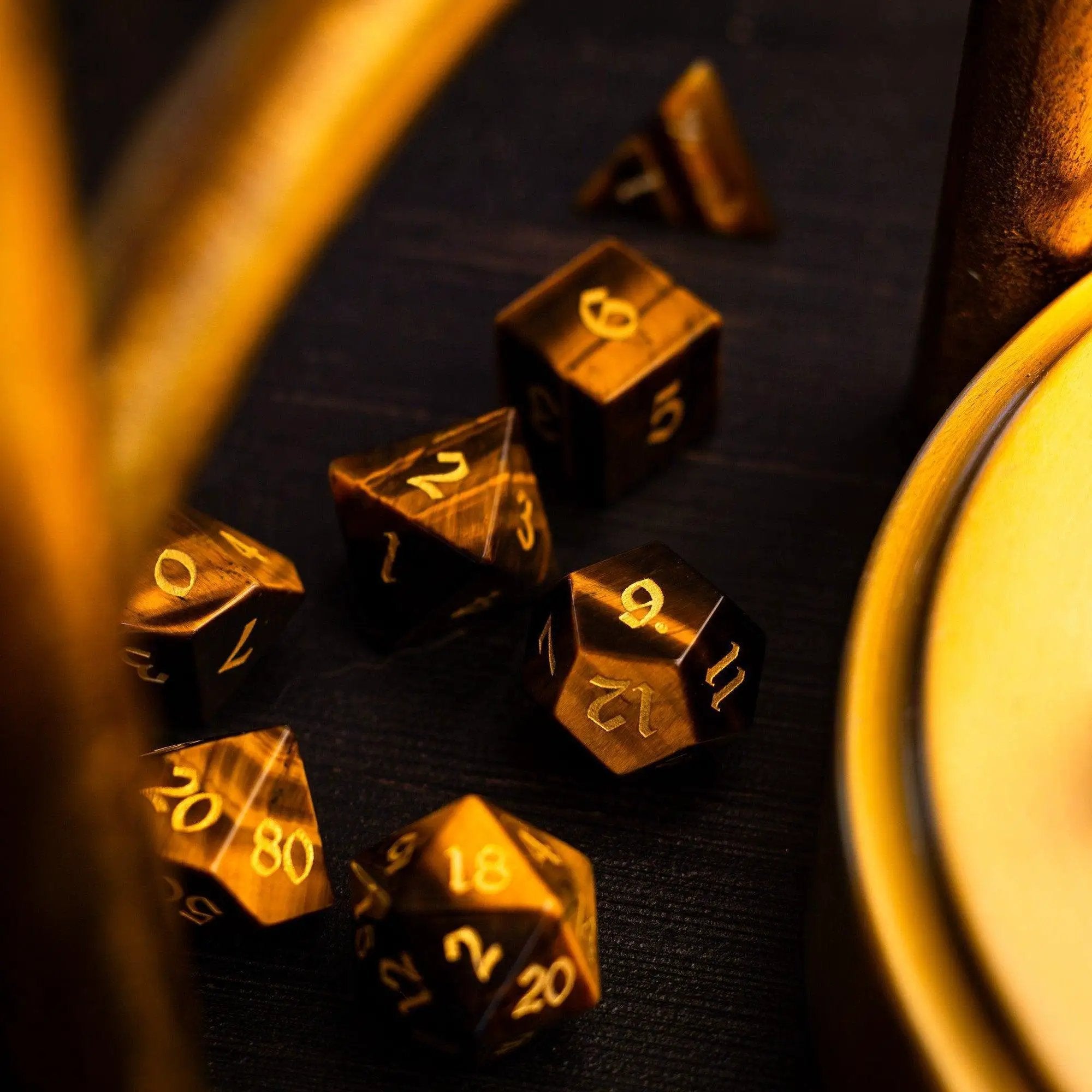 Yellow tiger's eye gemstone DND dice set by Runic Dice, featuring polished, colorful gemstone dice for tabletop gaming.