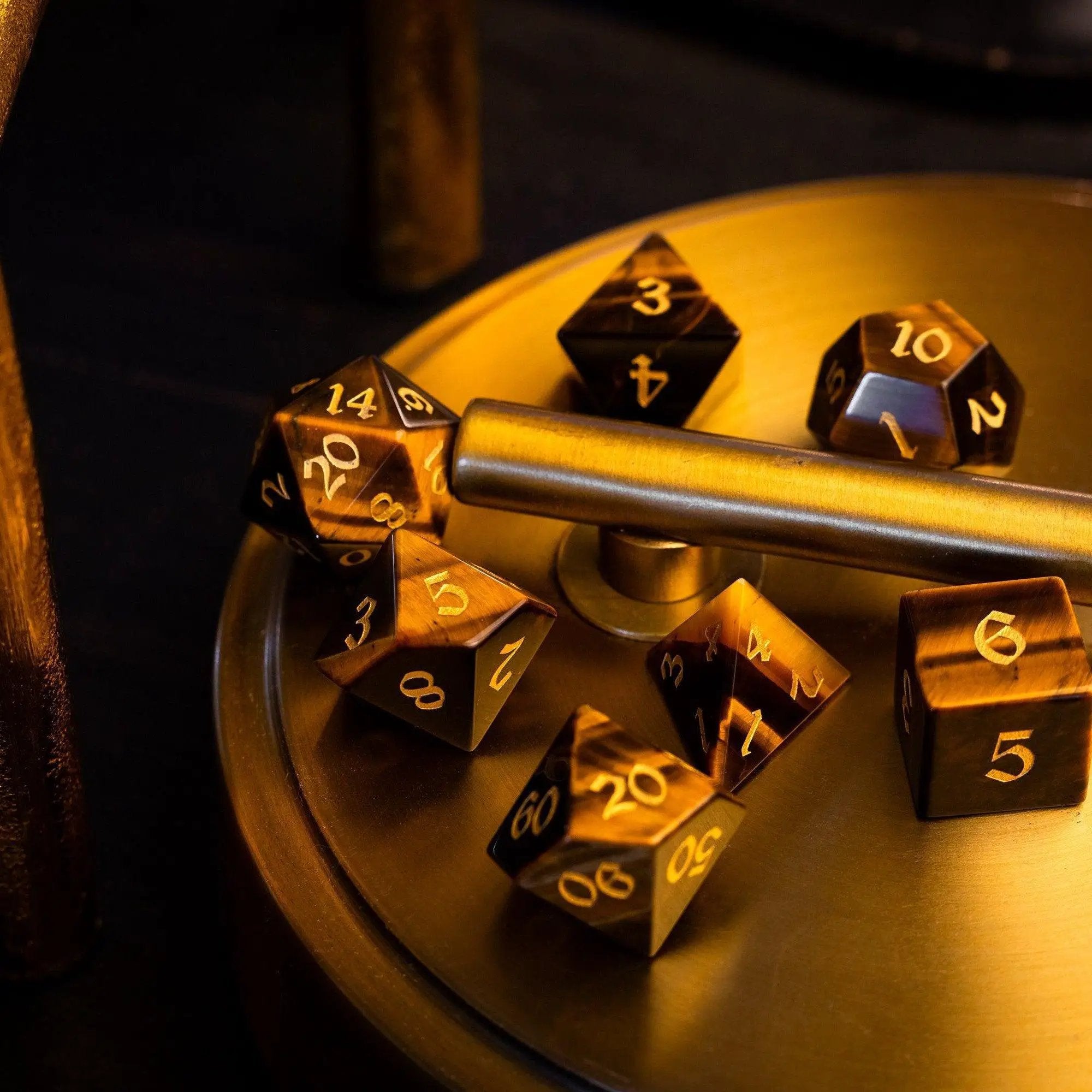 Yellow Tigers Eye gemstone DND dice set by Runic Dice, featuring polished, natural stone dice for tabletop gaming.