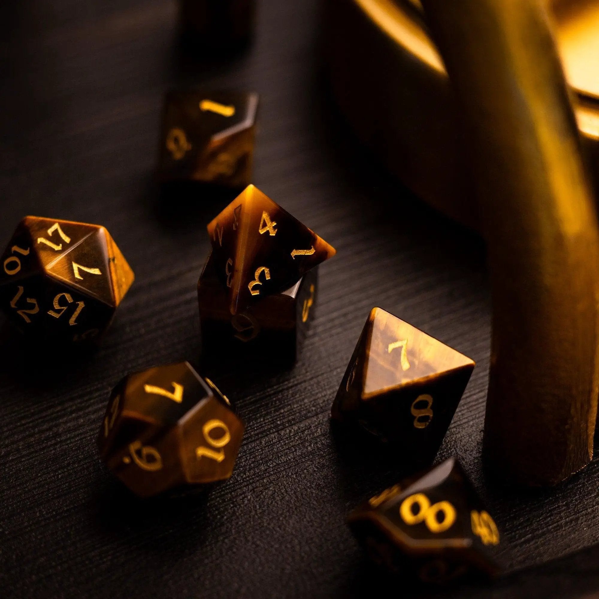 Yellow tigers eye gemstone DND dice set by Runic Dice, featuring polished, vibrant gemstone dice for tabletop gaming.