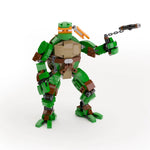 Custom LEGO Michelangelo TMNT figure made with LEGO parts by B3 Customs, shown in a white-themed design.
