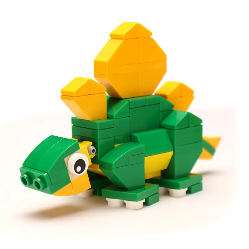 Custom LEGO Stegosaurus dinosaur model made with B3 Customs LEGO parts, featuring white and green bricks on a white background.