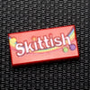Custom printed LEGO Skittish candy 1x2 tile by B3 Customs, featuring detailed colorful candy design on LEGO brick.
