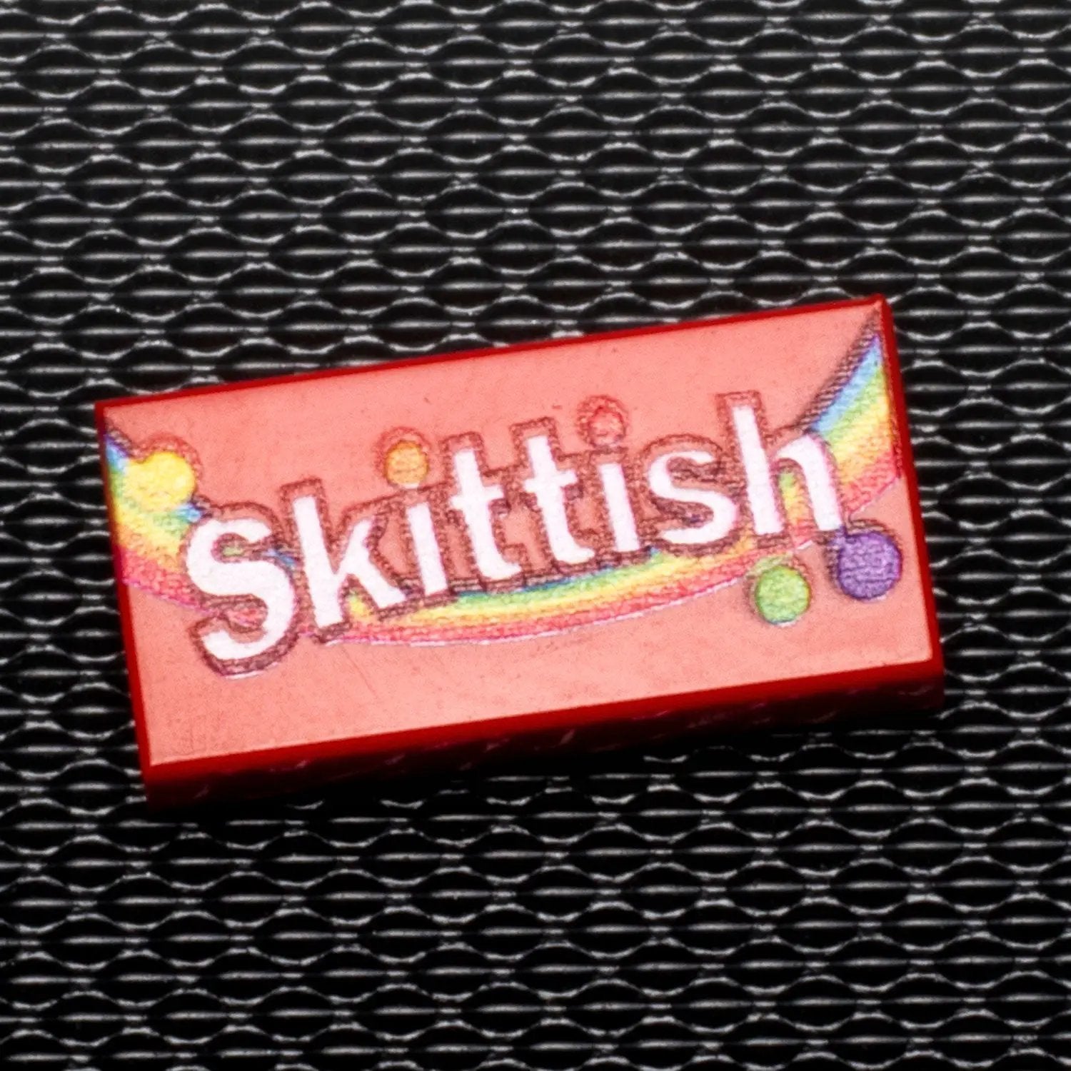 Custom printed LEGO Skittish candy 1x2 tile by B3 Customs, featuring detailed colorful candy design on LEGO brick.