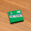 Custom printed LEGO solitaire 2x2 tile by B3 Customs featuring intricate design on white LEGO brick.